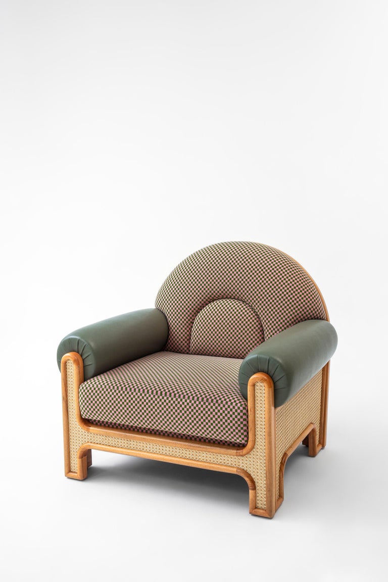 The N-gene armchair is a reinterpretation of an armchair designed by Merve’s uncle, interior designer, Engine, in the 1970s. The N-Gene is re-envisioned with caning, and is upholstered in a checker textile with olive leather arms. This entirely