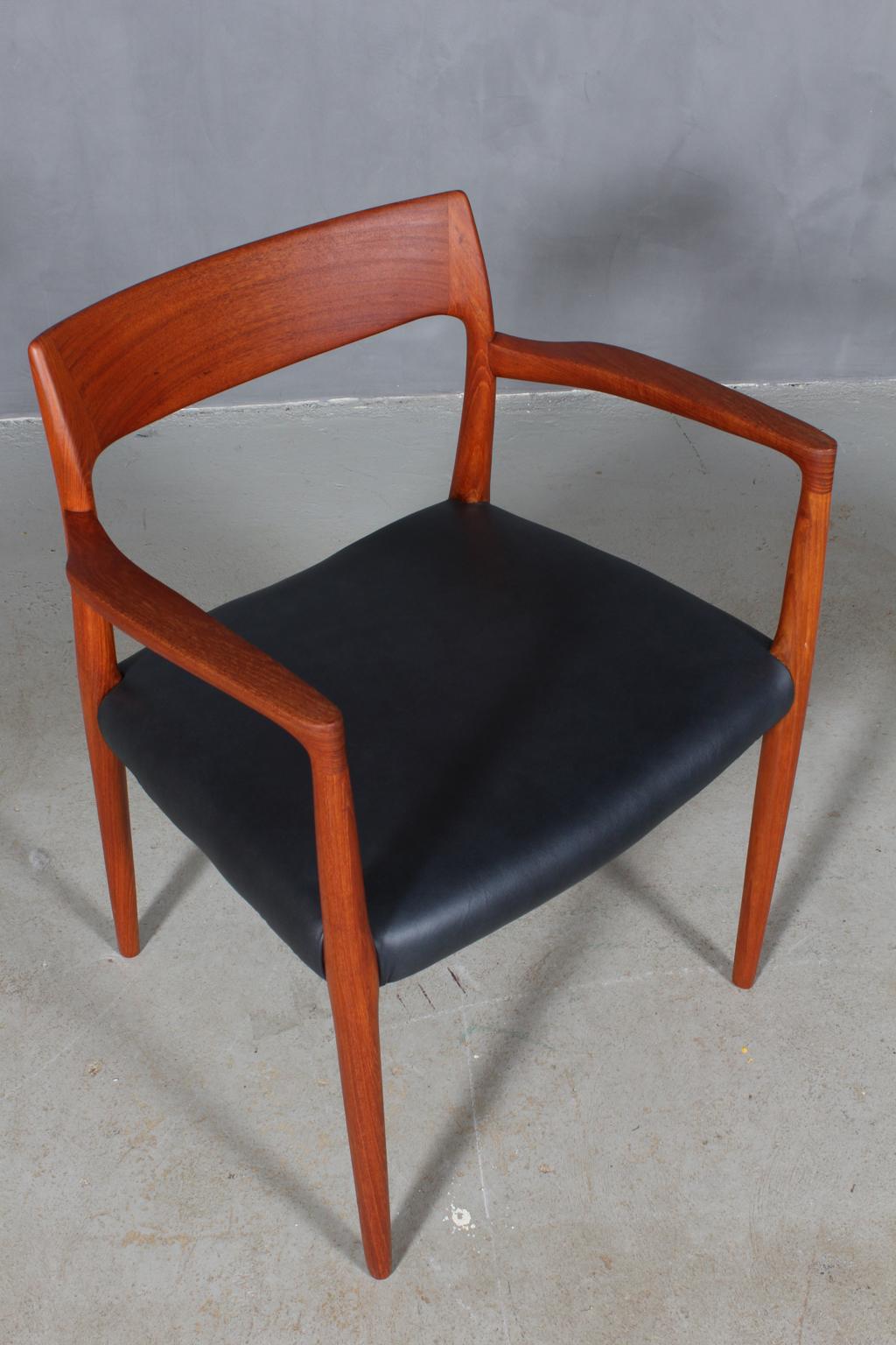 N. O. Møller armchair with frame of solid teak.

Seats new upholstered with black aniline leather

Model 77, Made by J. L. Møller, Denmark, 1960s.