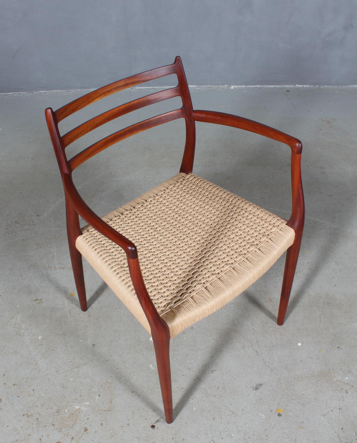 N. O. Møller armchair with frame of solid oiled mahogany.

Seat new weaved with Danish paper cord.

Model 62, Made by J. L. Møller, Denmark, 1960s.