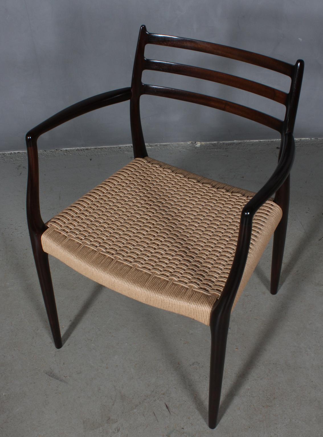 N. O. Møller armchair with frame of solid lacquered mahogany.

Seat weaved with Danish paper cord.

Model 62, made by J. L. Møller, Denmark, 1960s.