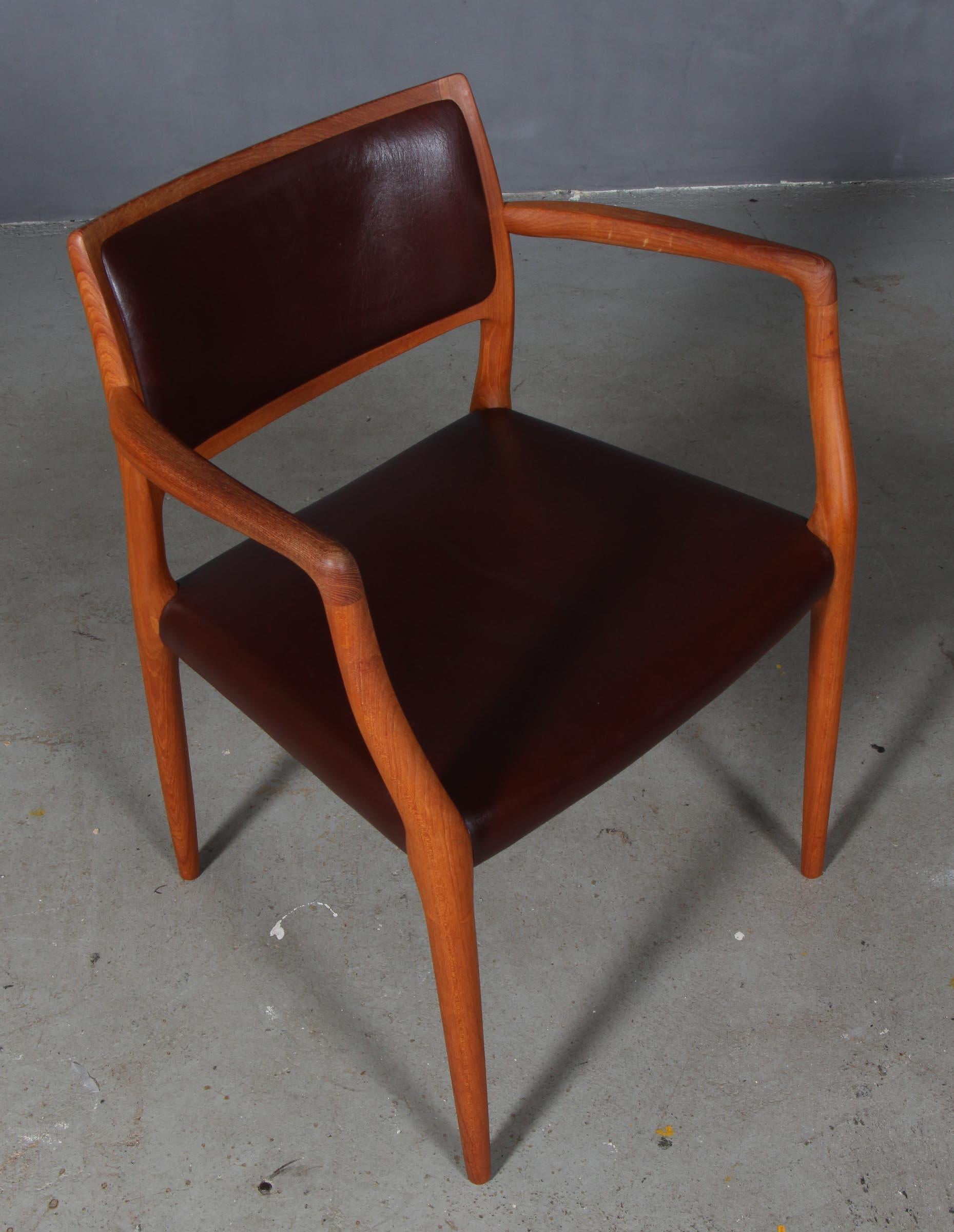 N. O. Møller armchair with frame of solid teak

Seat and back original upholstered with brown leather.

Model 65, made by J. L. Møller, Denmark, 1960s.