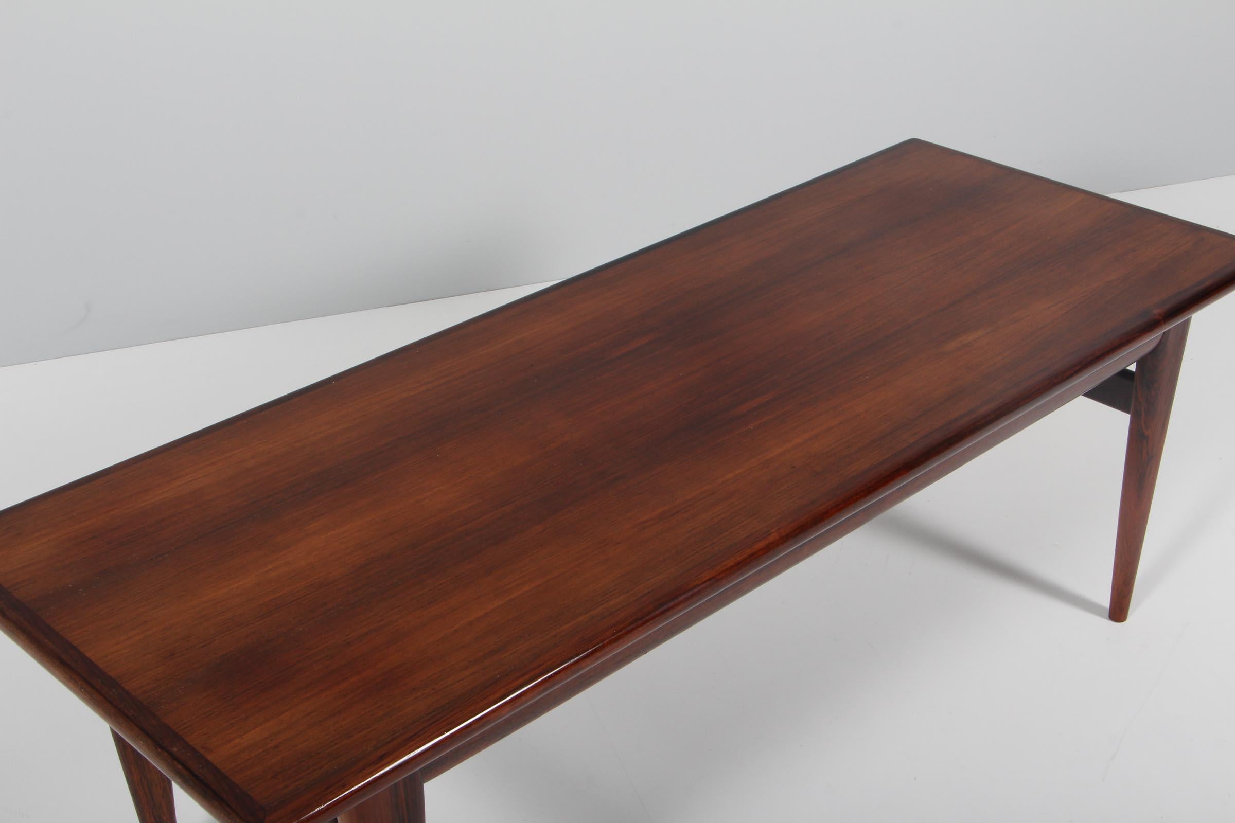 N. O. Møller coffee table in partly solid rosewood.

Made by J. L. Møller.