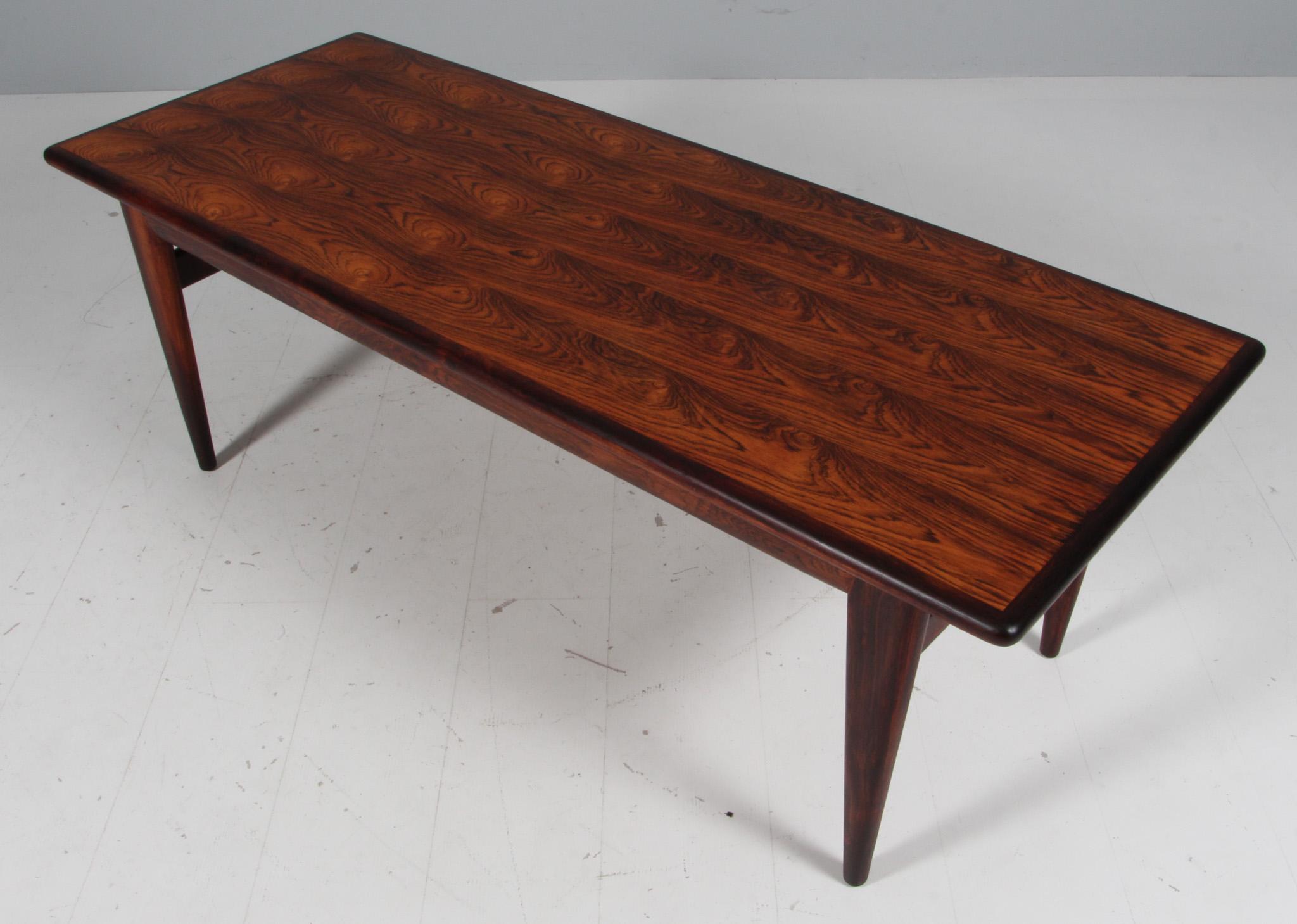 N. O. Møller coffee table in partly solid rosewood.

Made by J. L. Møller.