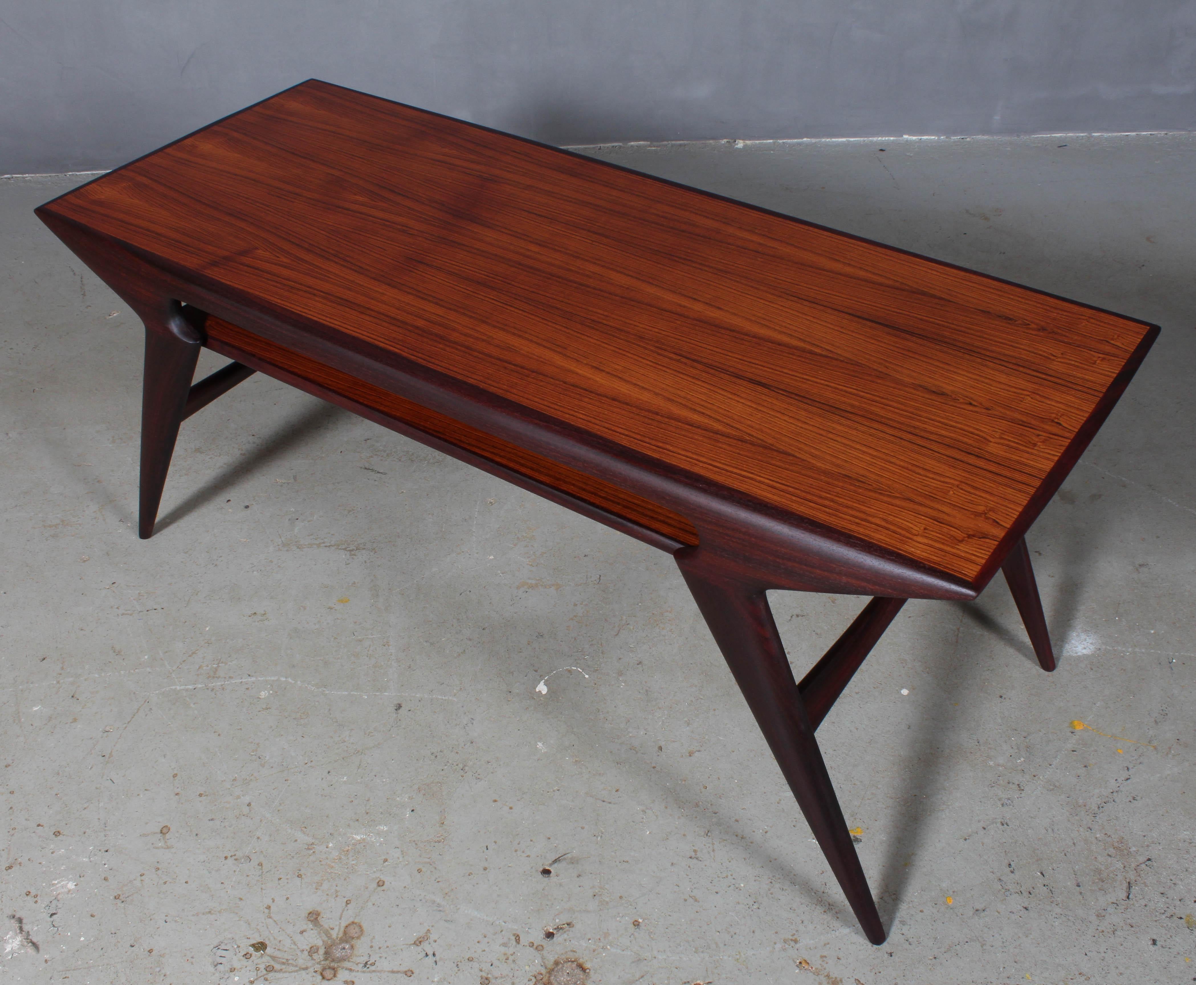 N. O. Møller coffee table in partly solid rosewood. With newspaper shelf.

Model 34, made by J. L. Møller.