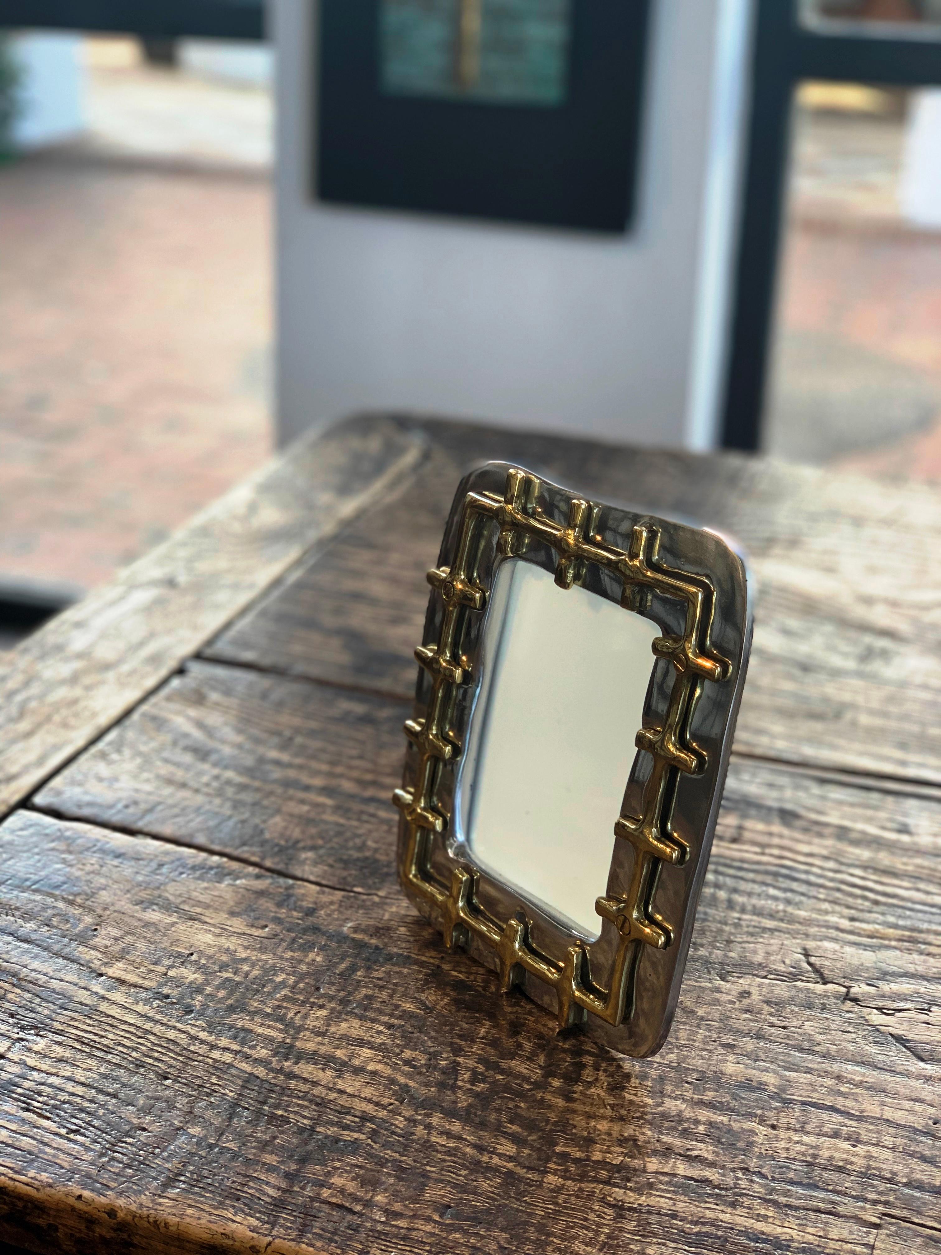 The decorative Picture frame , was created by David Marshall, it is made of  sand cast brass. 
Handmade, mounted and finished in our foundry and workshop in Spain from recycled materials.
Certified authentic by the Artist David Marshall with his