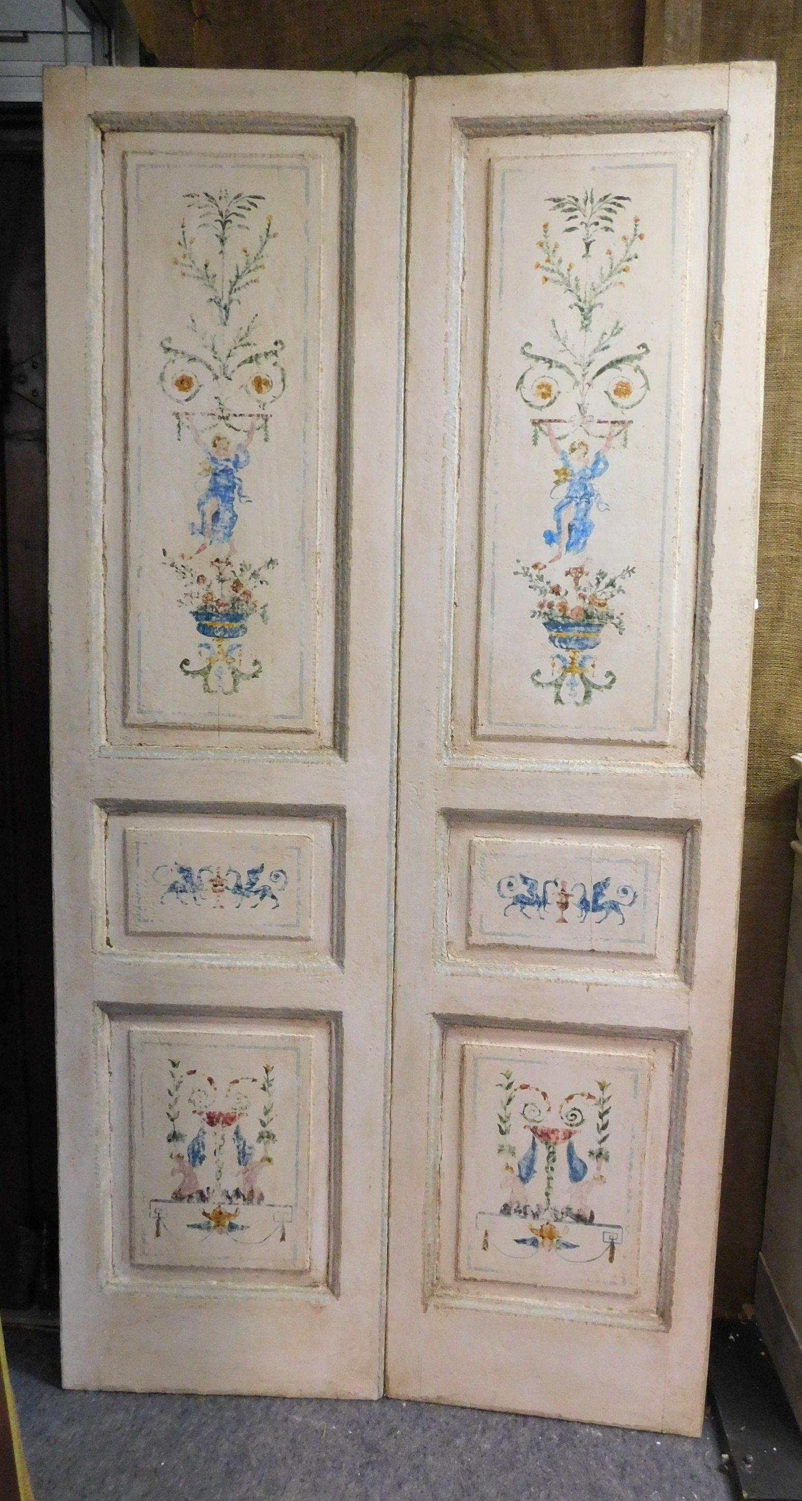 N.2 ancient double-wing doors, white background and hand painted with colored allegories, typical design of the time, built in the late '700, coming from Umbria (Italy).
They are sold without a frame, but they look beautiful on both sides, so you