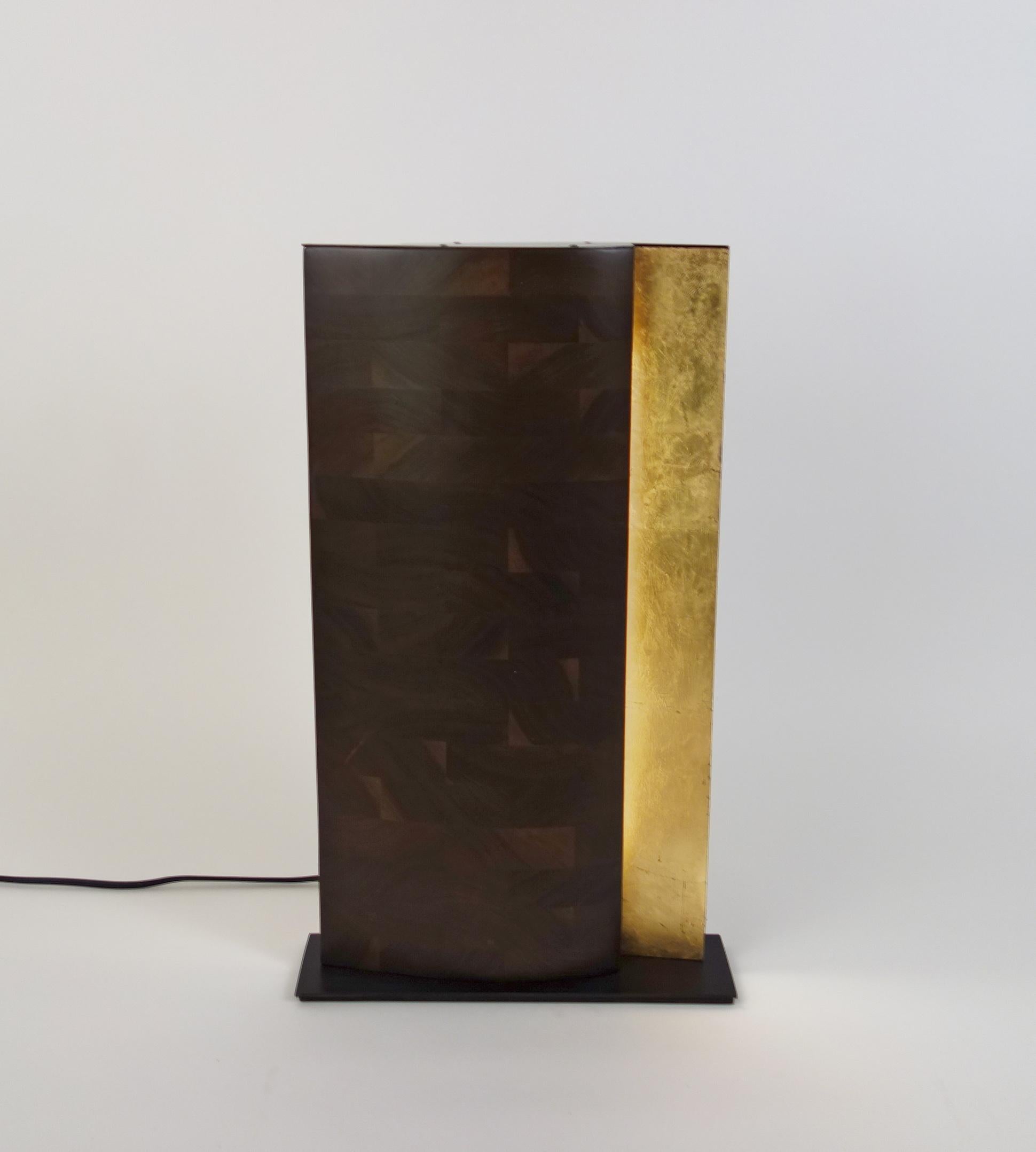 N2 Panel Lamp by Aaron Scott
Dimensions: D 11.5 x W 34.5 x H 57.5 cm
Materials: Walnut, blackened steel, acrylic, LED lamps, gold leaf.
Also available in other woods: bleached walnut. 

All our lamps can be wired according to each country. If