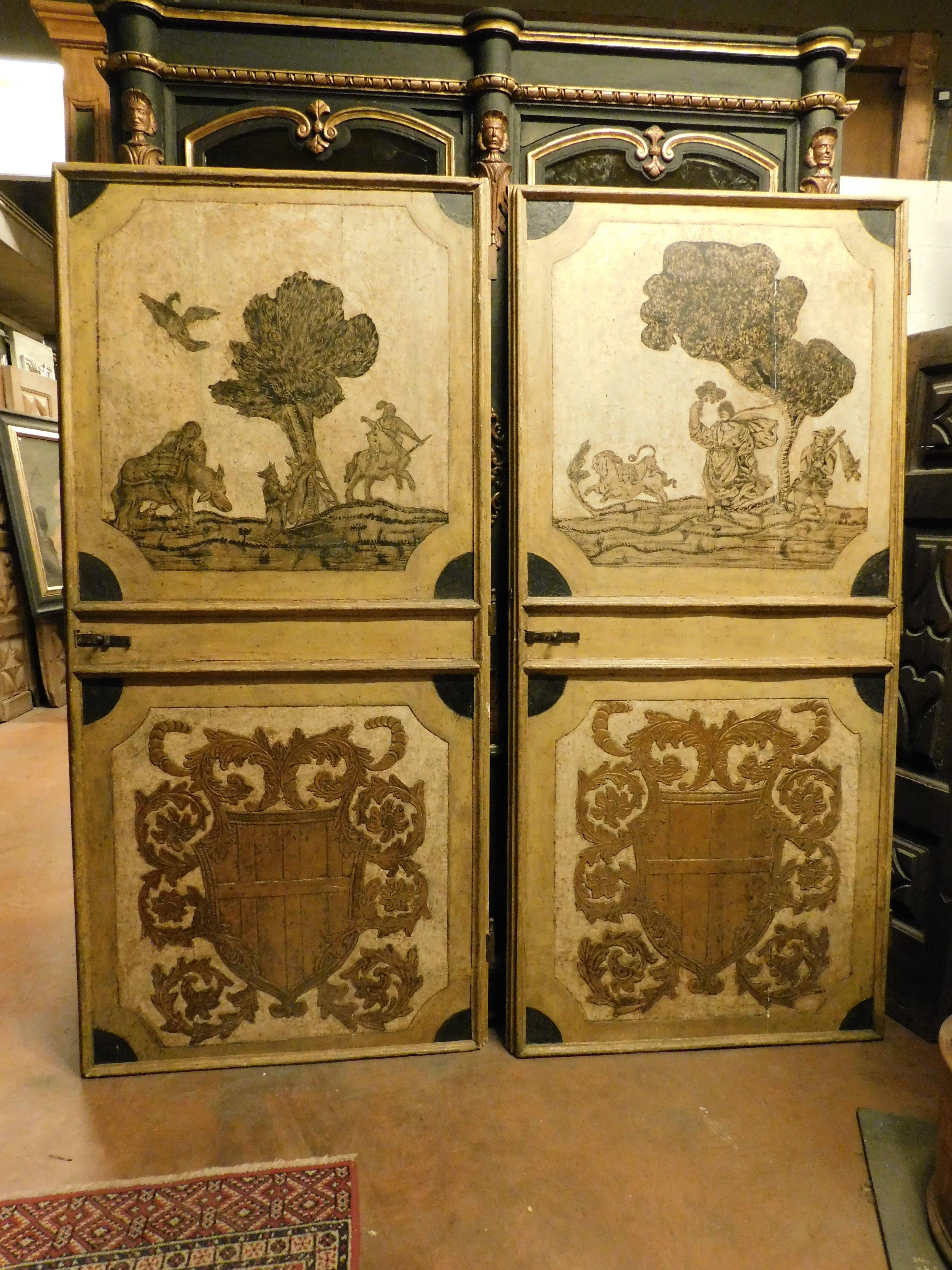 Incredible set of 2 ancient interior doors, richly decorated by hand, decorations with noble coats of arms in relief in the panel below and a bent landscape (painted) in the panel above, smooth and lacquered polenta yellow back, hand-built for a