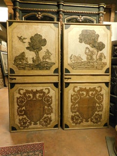 n.2 puertas ricamente decoradas, escudos en relieve, paisaje encorvado, Austria