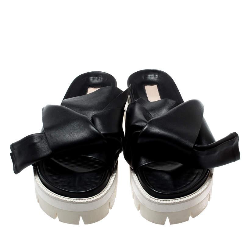 This black pair refines your look with its unique style. These N21 slides are crafted from leather and detailed with the established knot design on the uppers. They come set on platforms for a slight lift.

Includes
Original Box