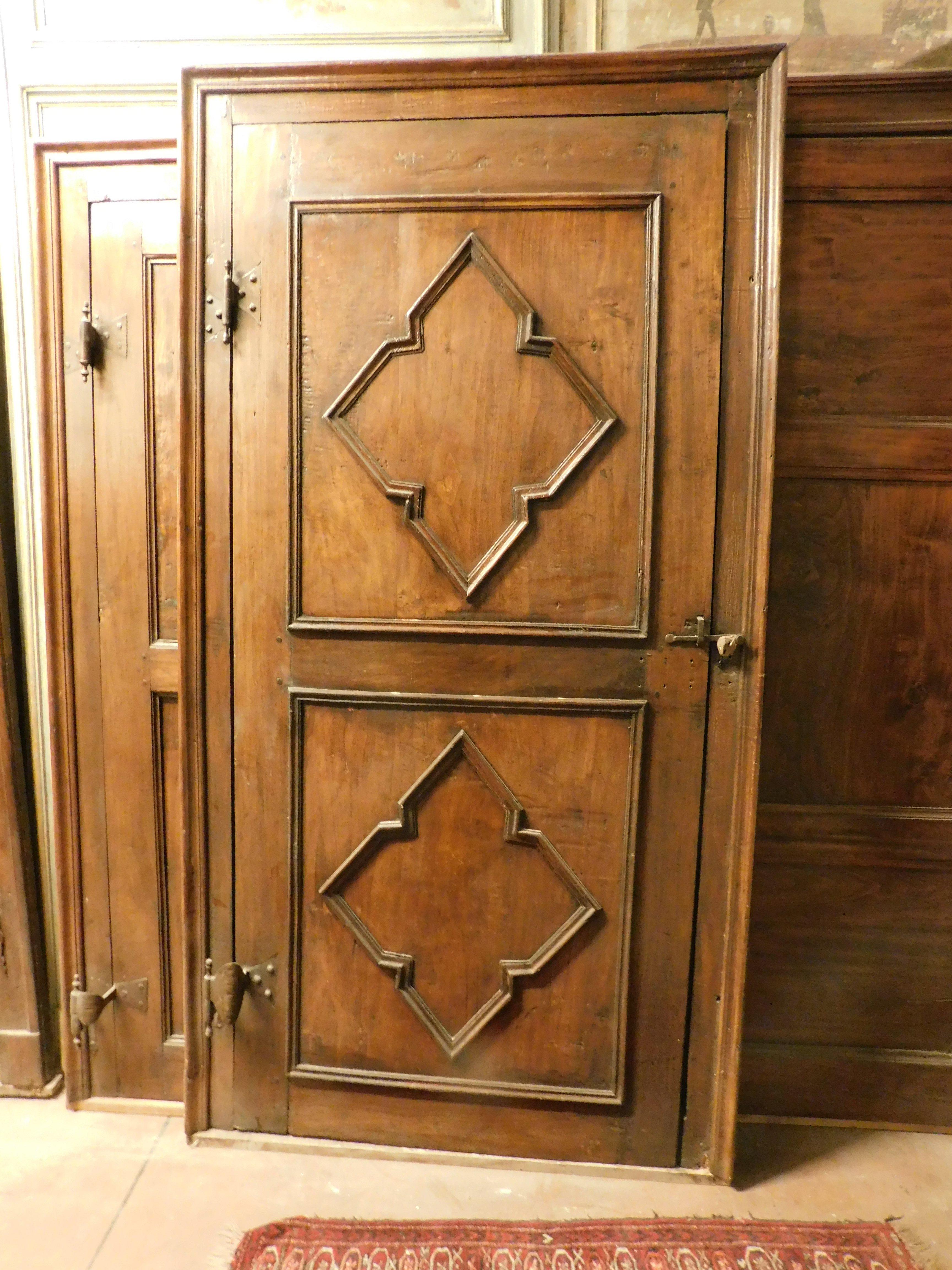 set of 3 sculpted poplar doors, coming from the same house even if not identical: two identical and one with a similar panel, all complete with original frame and irons, the panels have geometric decorations typical of the 18th century, built in