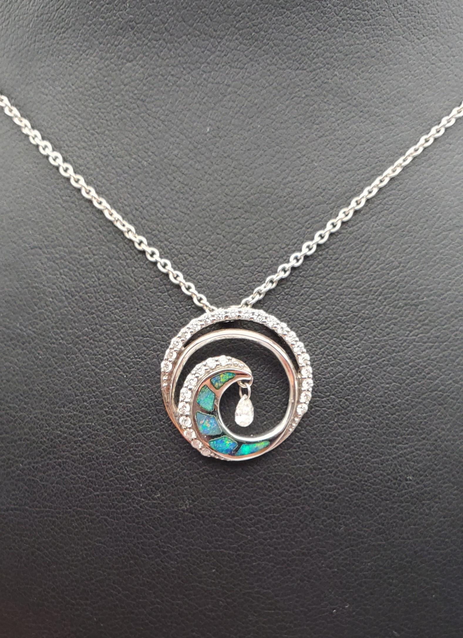 Beautiful 14K White Gold Ultimate Wave Shimmer Pendant. This design features blueish-green opal inlay and 0.39cttw of round brilliant cut diamonds, including a 0.08ct shimmer diamond. It gives the look of a cresting ocean wave when the sunlight hits