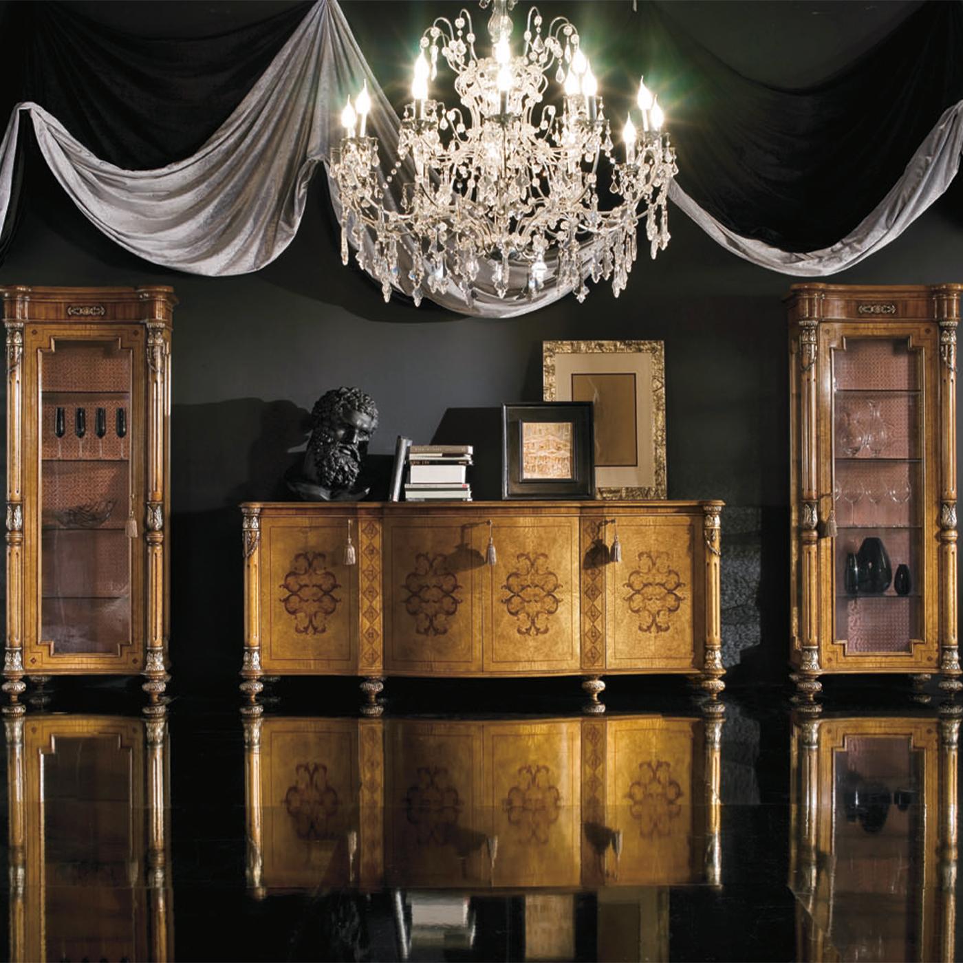 This sophisticated yet imposing wooden sideboard is an exquisite example of fine joinery. The minute and intensely decorative carved elements adorning the flattened feet and the sideboard's side elements are accented with bright silver leaf, their