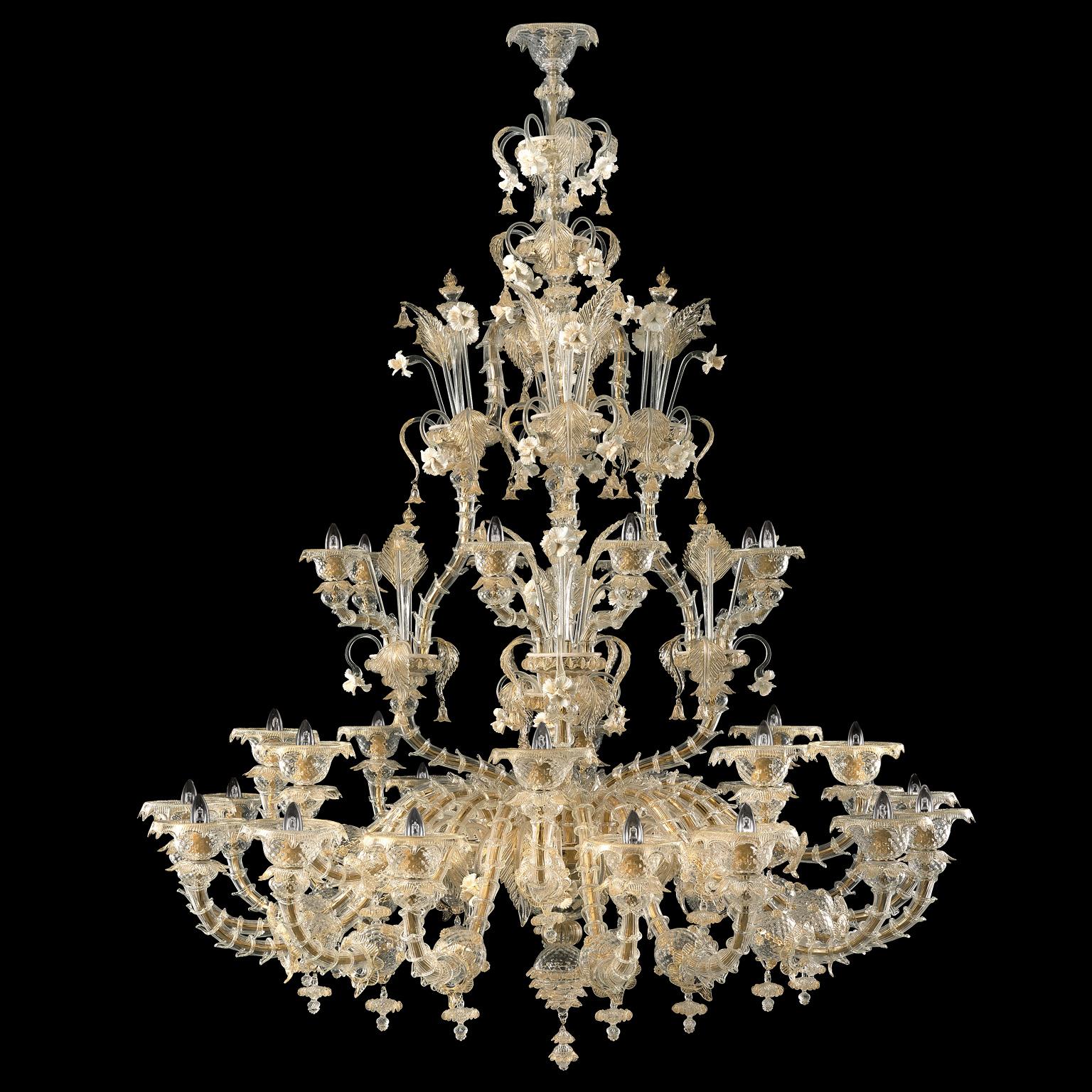 Nabucco chandelier 16+8+8 lights, artistic crystal Murano glass, gold details, white and gold vitreous flowers by Multiforme

Among our collections inspired from the 18th century Venice, the Rezzonico chandelier Nabucco is one of the most majestic.
