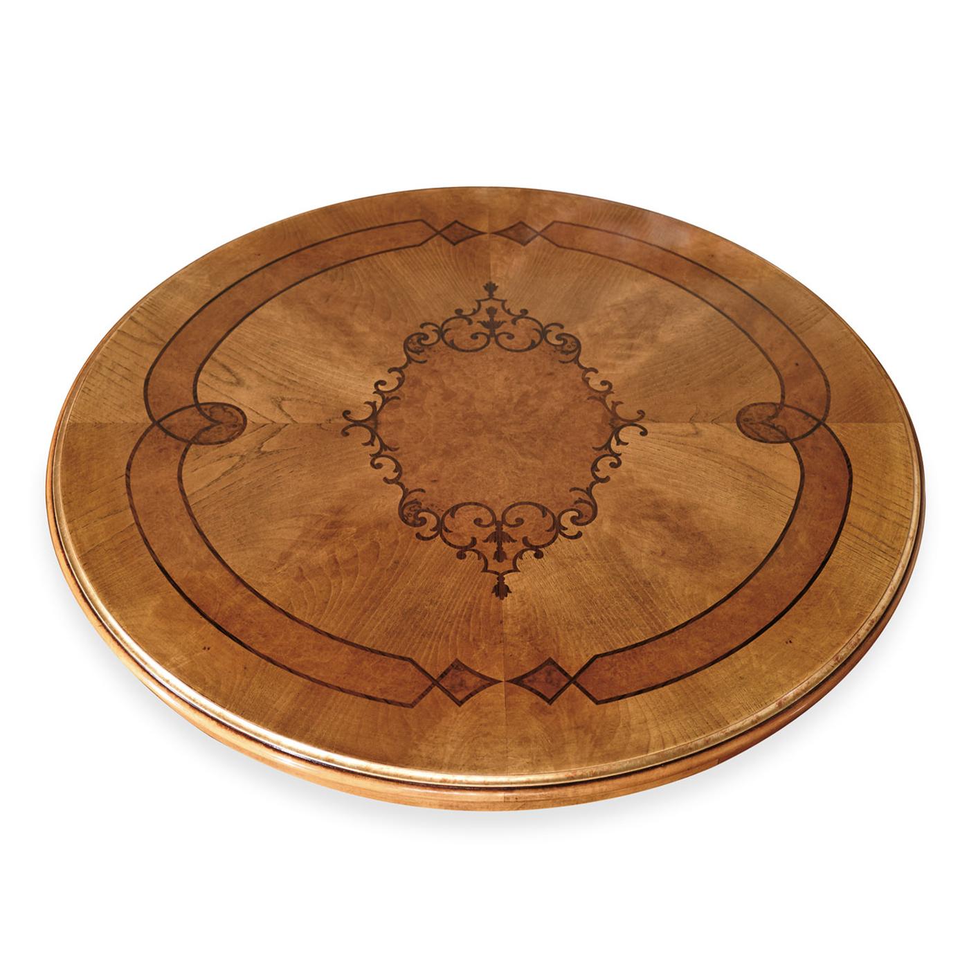 An impressive focal point in any classic dining room, this stately table is crafted of first-rate wood enriched wih precious inlays blending rosewood, feathered ash, and walnut briar. The thickness of the round top is in perfect harmony with the