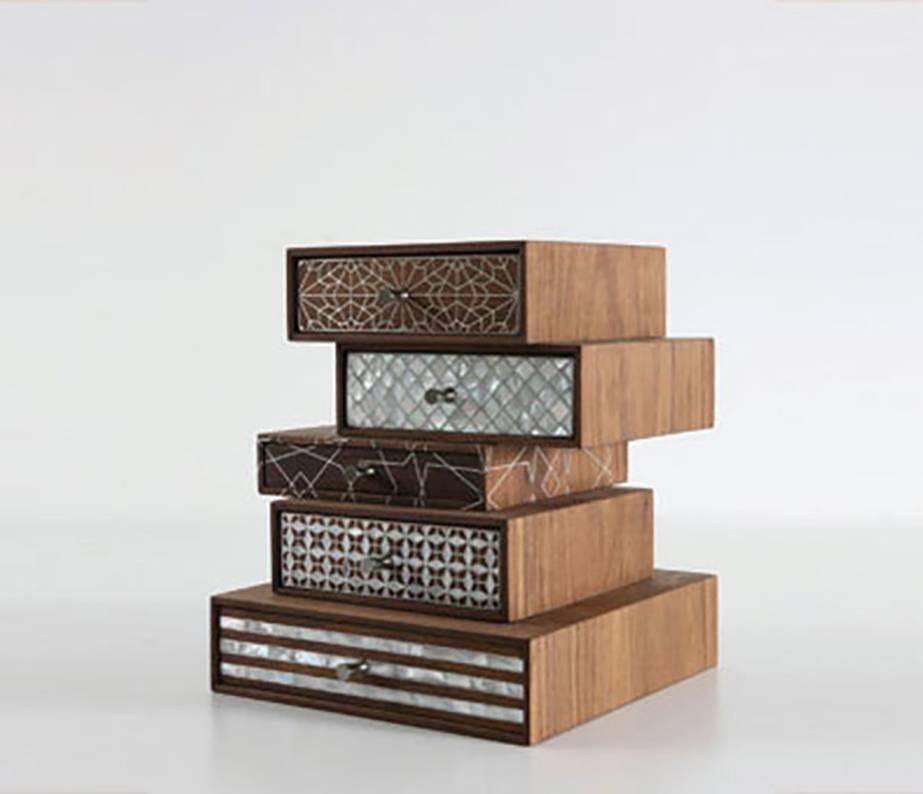 Nada Debs patchwork. A stack of drawers; unevenly mounted upon each other with five different inlay pattern on each drawer. Ideally used for jewelry, but too pretty not to be displayed as an “it” piece.
Handmade with genuine