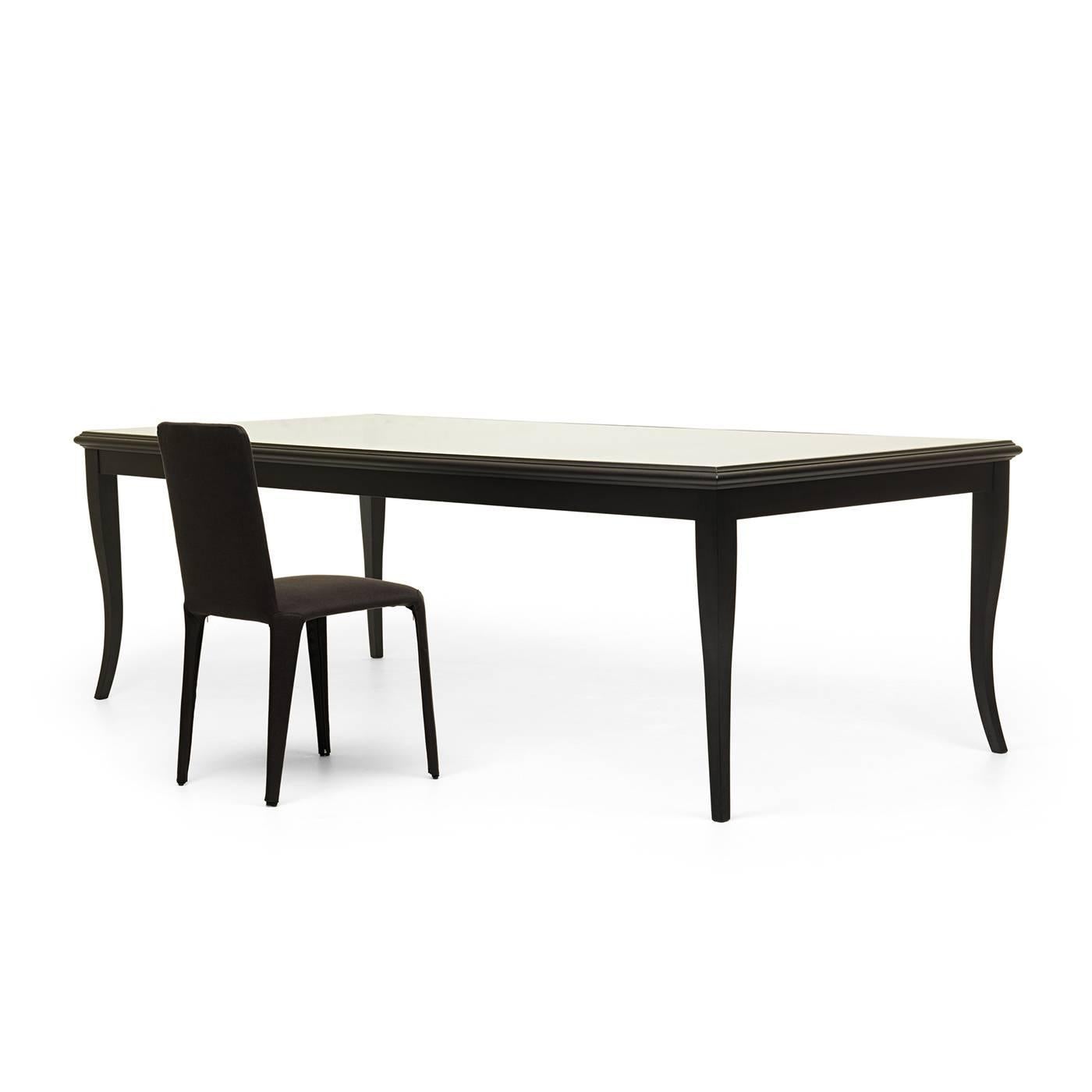 Designed in 2013 by Federico Carandini, this elegant dining table reinterprets the silhouette of an antique table with a contemporary sensibility, creating a light, sophisticated piece that will complement any decor. The tempered glass top showcases