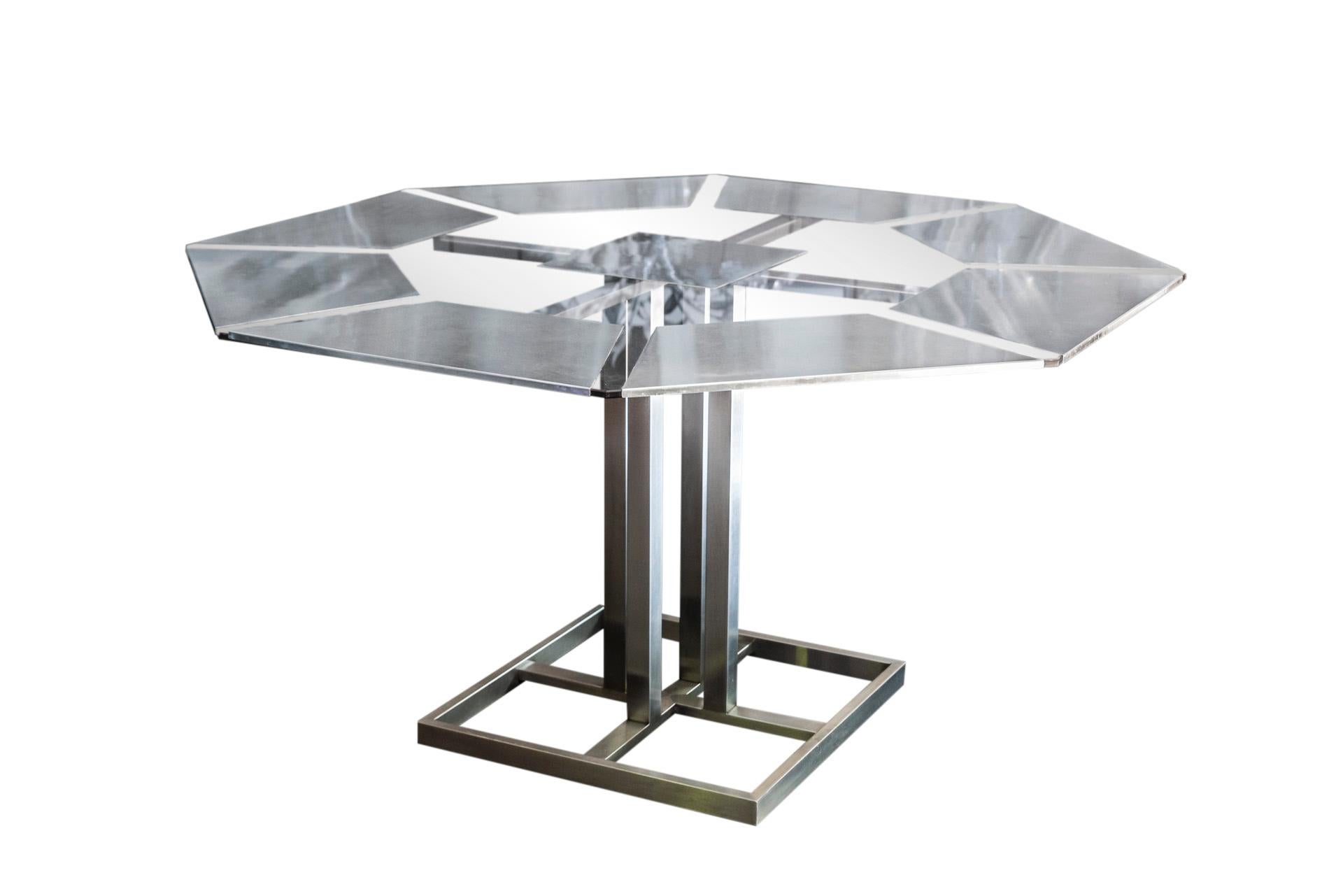 Nadine Charteret, 
Dining table, 
Inox and glass, octogonal glass tabletop with metal inclusions,
France, circa 1970.

Measures: Diameter 140 cm, height 74 cm.