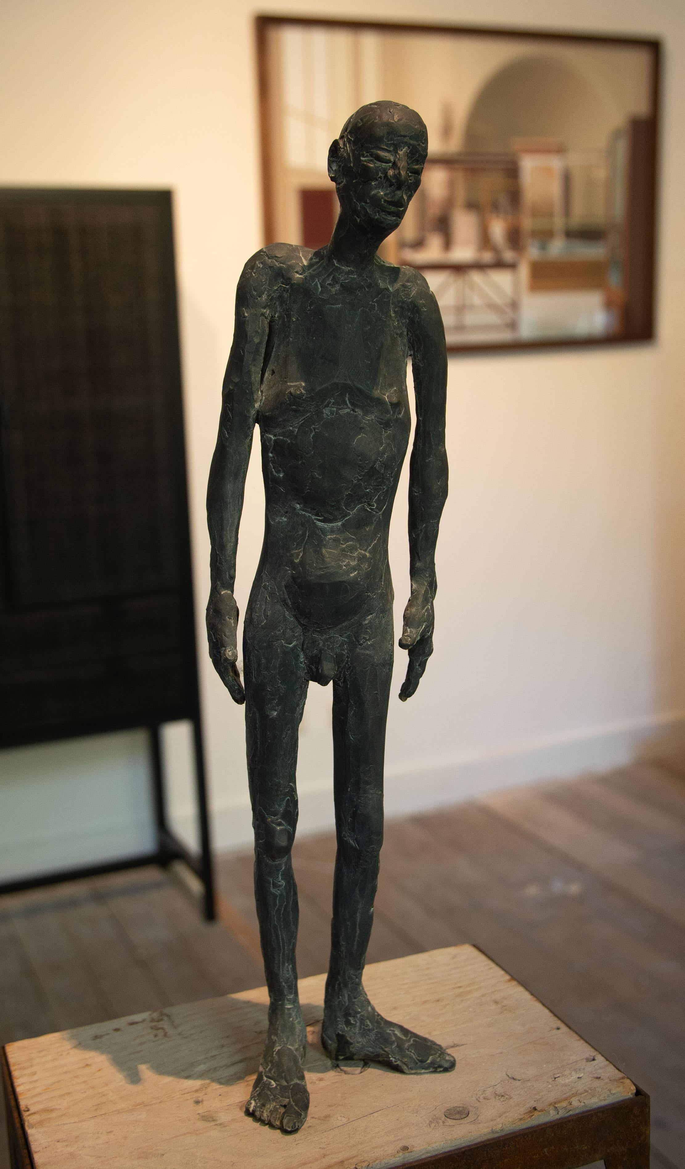 Bronze sculpture of a man standing, called 'At that time' - Gold Figurative Sculpture by Nadine De Meester