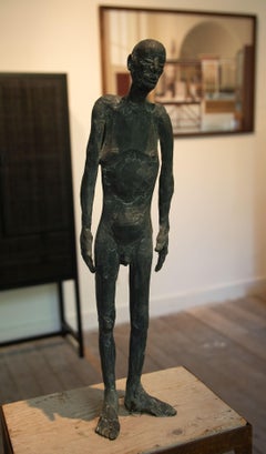 Bronze sculpture of a man standing, called 'At that time'
