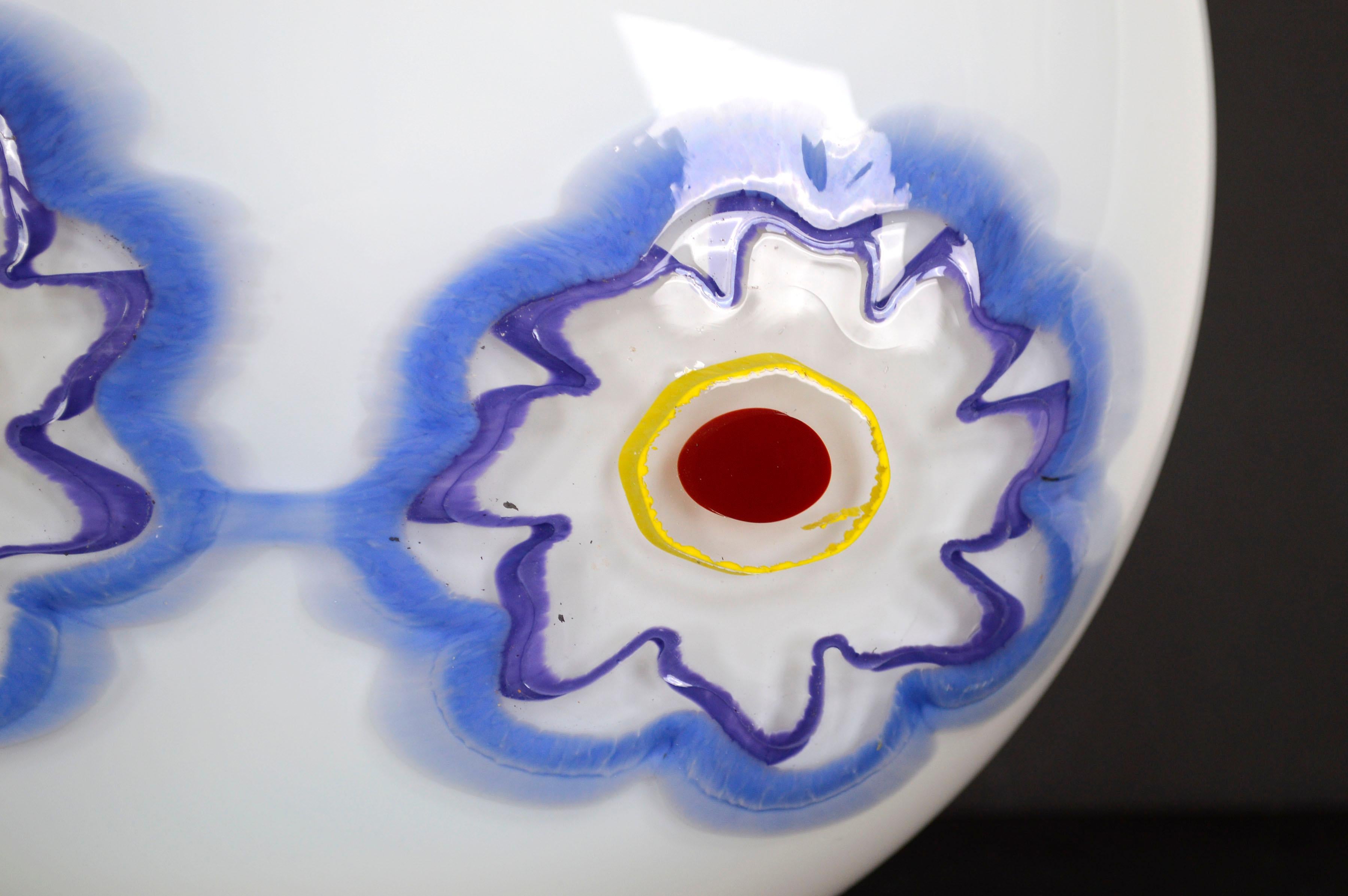 Wonderfully modern white blown glass vase with two blue flowers and red rim by Nadine Saylor (American, 20th Century), 2005. Signed and dated on bottom. Condition: Excellent. Measures 9.5