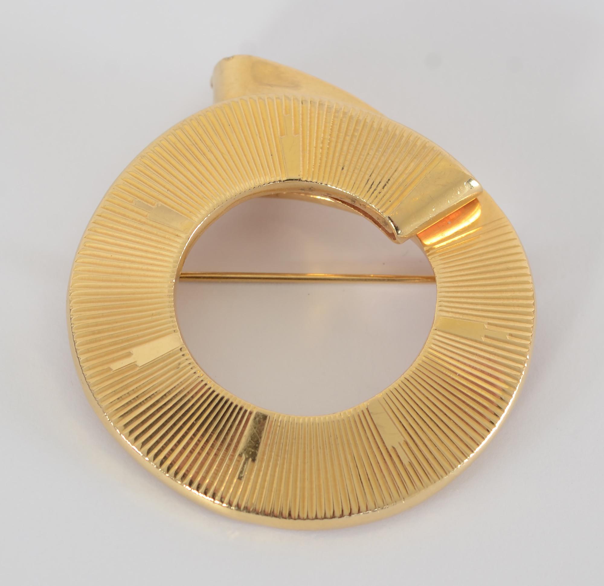 Retro 14 karat gold circle pin by Nadia Buckley (Born Countess Nadja Ostrovska in Rome) . Buckley was one of the few outstanding women in the field of jewelry design in the mid 20th century. She had stores in New York and Dallas. Her pieces were