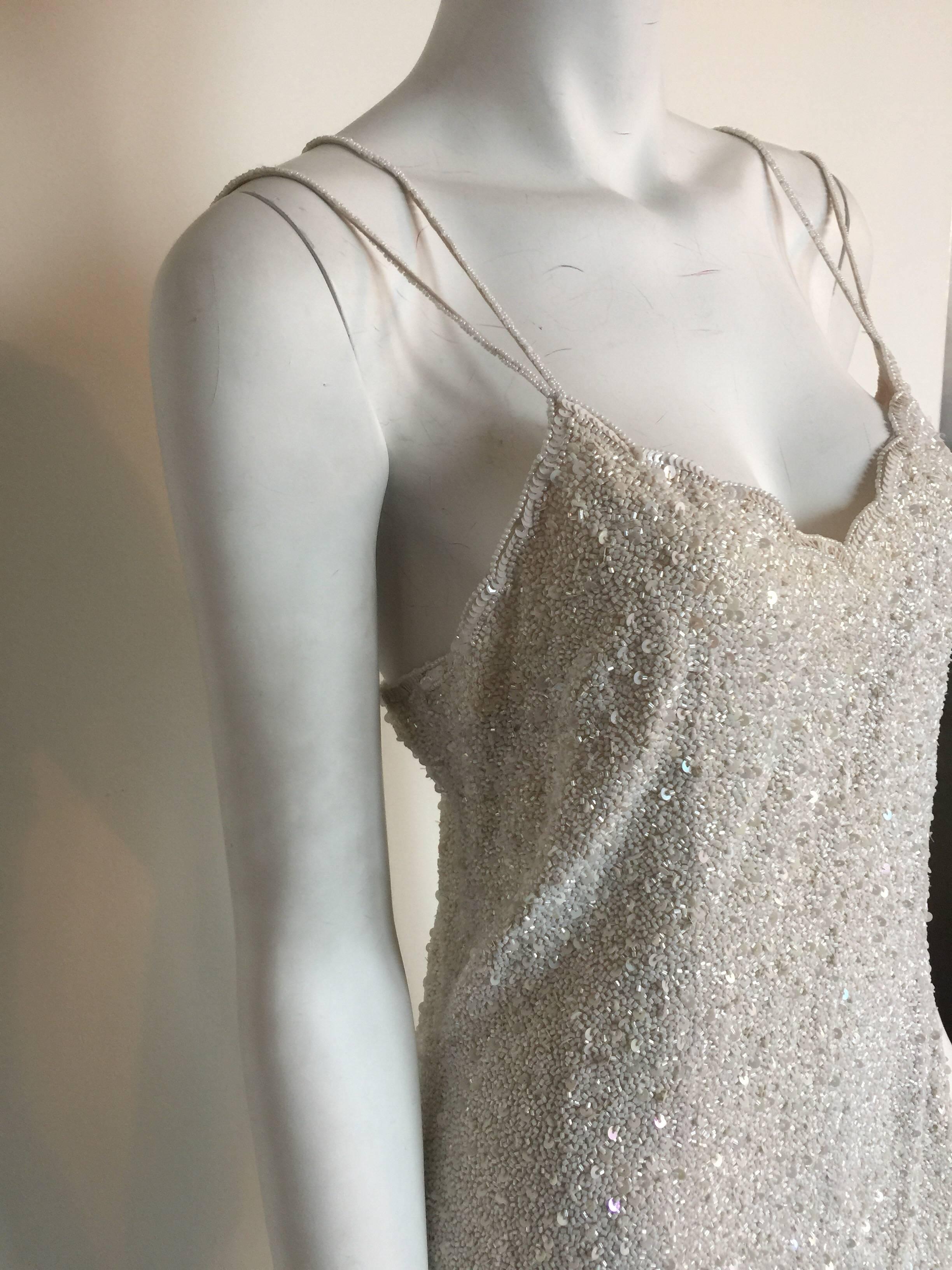 This white full beaded mini dress is Naeem Khan for Riazee Nights.  It is co-labelled with Bergdorf Goodman.  It is listed a size 12 but please check measurements.  A great bridal shower or second wedding dress.