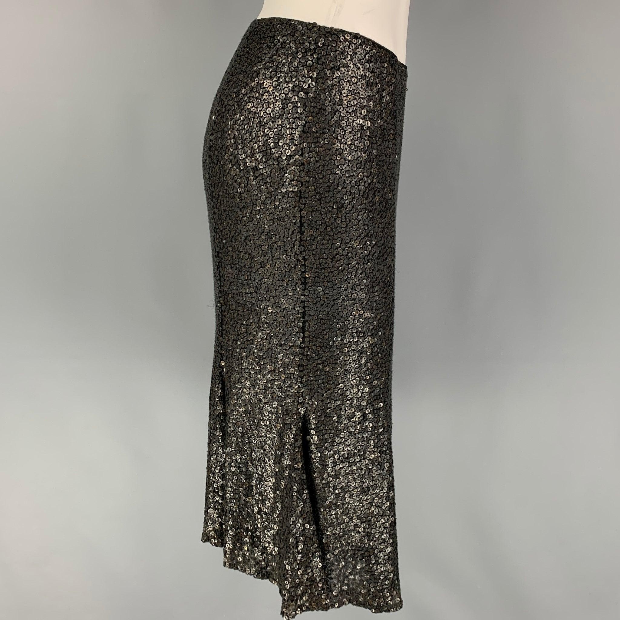 NAEEM KHAN skirt comes in a black & charcoal sequin material with a chiffon liner featuring a tulip style and a side zipper closure.
Very Good
Pre-Owned Condition. 

Marked:   4 

Measurements: 
  Waist: 26 inches  Hip: 32 inches  Length: 23 inches