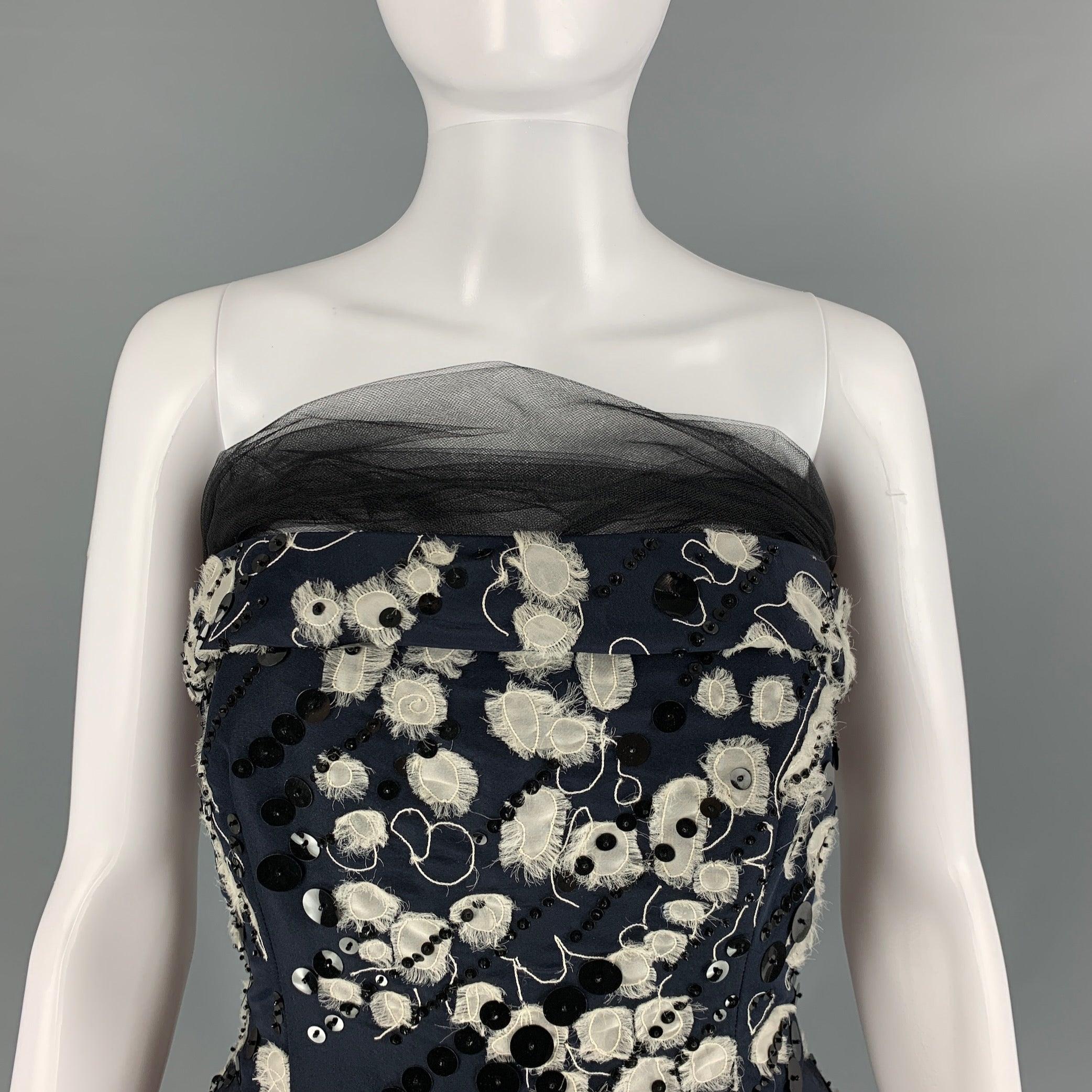 NAEEM KHAN custom made gown comes in a black & cream silk woven material featuring a strapless style, sequined details, a-line skirt, tulle at neckline and a side zipper closure. Made in USA.Very Good Pre-Owned Condition. Brand Tag Removed.