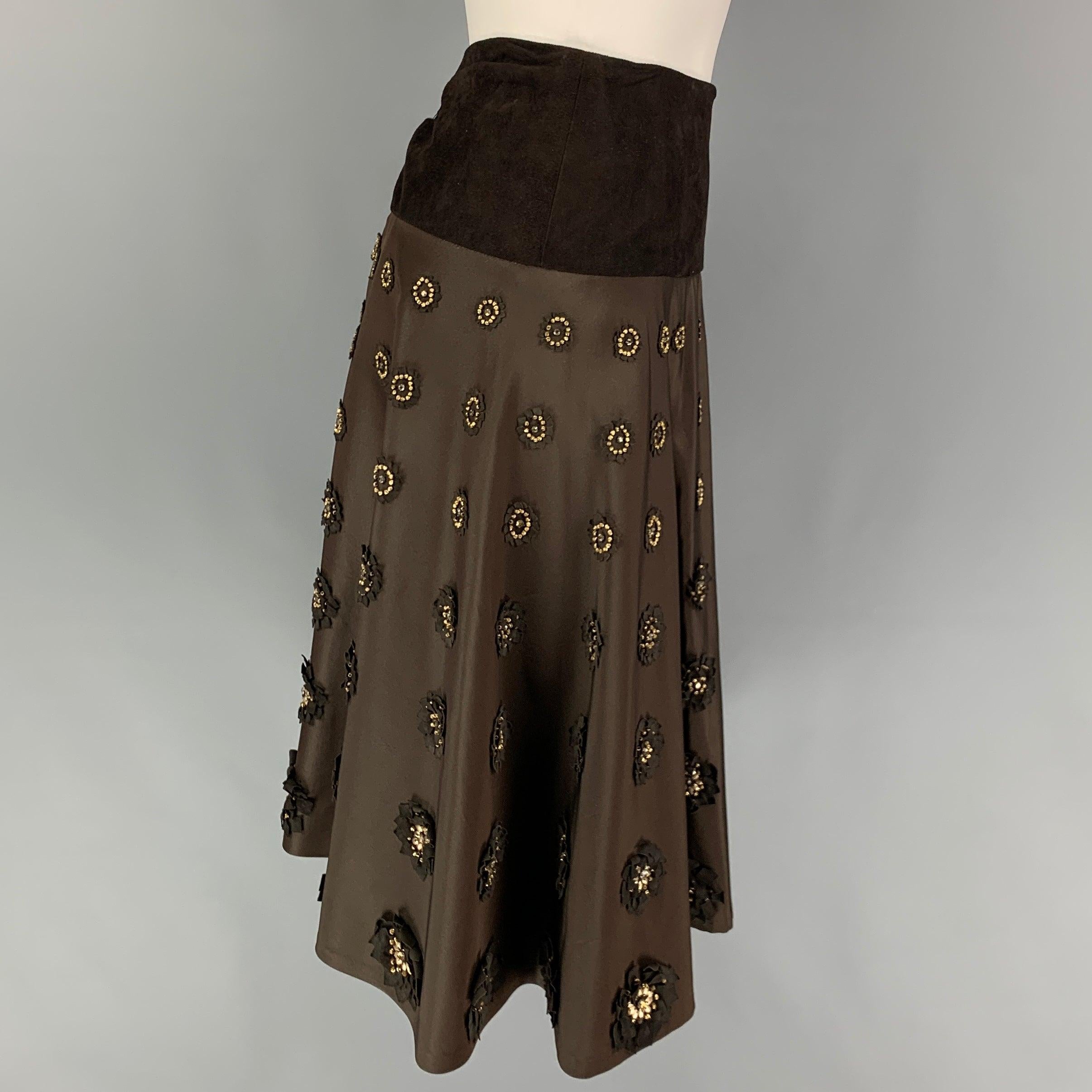 NAEEM KHAN skirt comes in a brown silk with a slip liner featuring a circle style, suede panel, leather beaded floral applique details, and a back zipper closure. Made in USA.
Very Good 
Pre-Owned Condition. 

Marked:   4 

Measurements: 
  Waist: