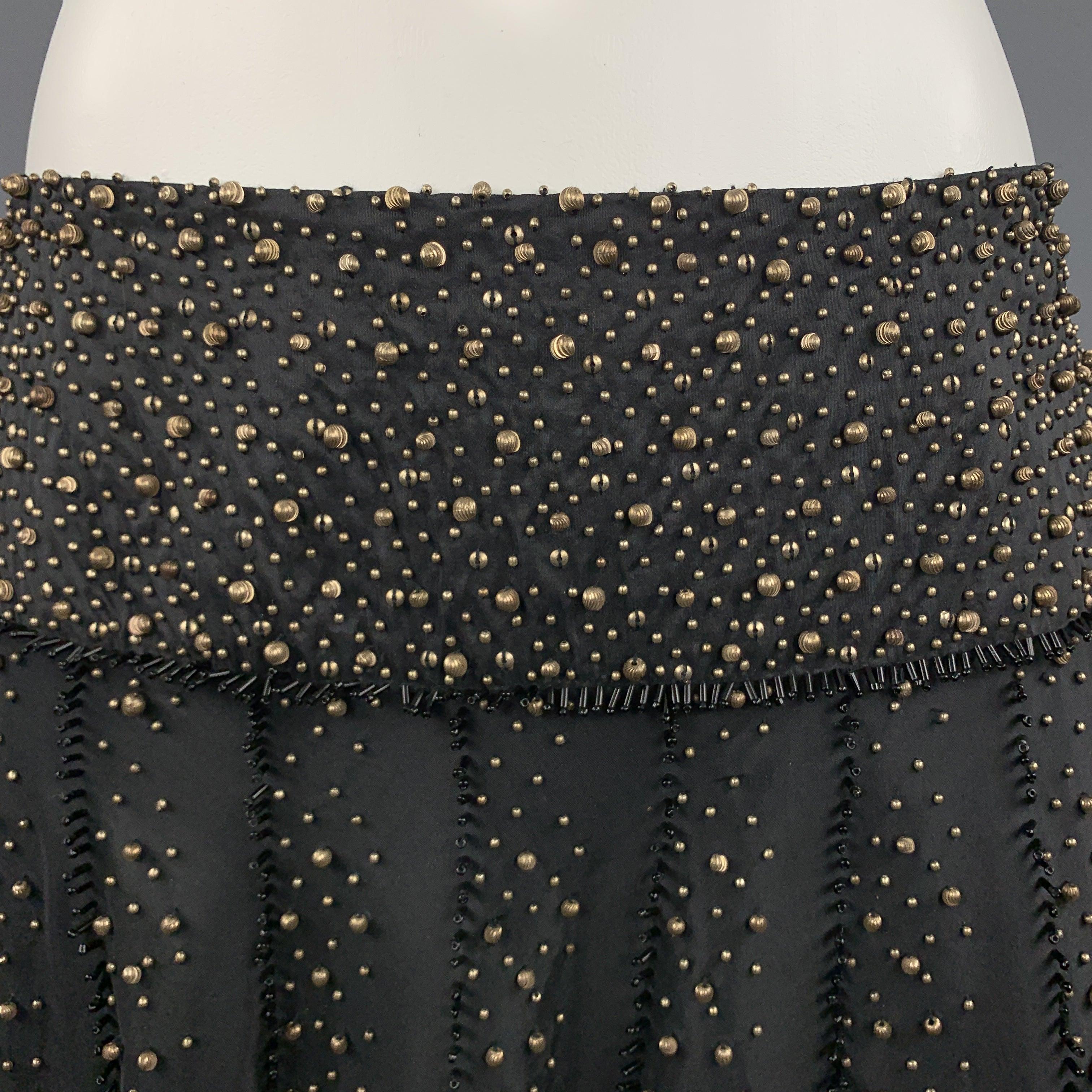 NAEEM KHAN A line skirt comes in black silk taffeta gold tone beadwork throughout and black bugle bead piping. Made in USA.Excellent
Pre-Owned Condition. 

Marked:   US 6 

Measurements: 
  Waist:
29 inches Hip: 60 inches Length: 25 inches 
  
  
