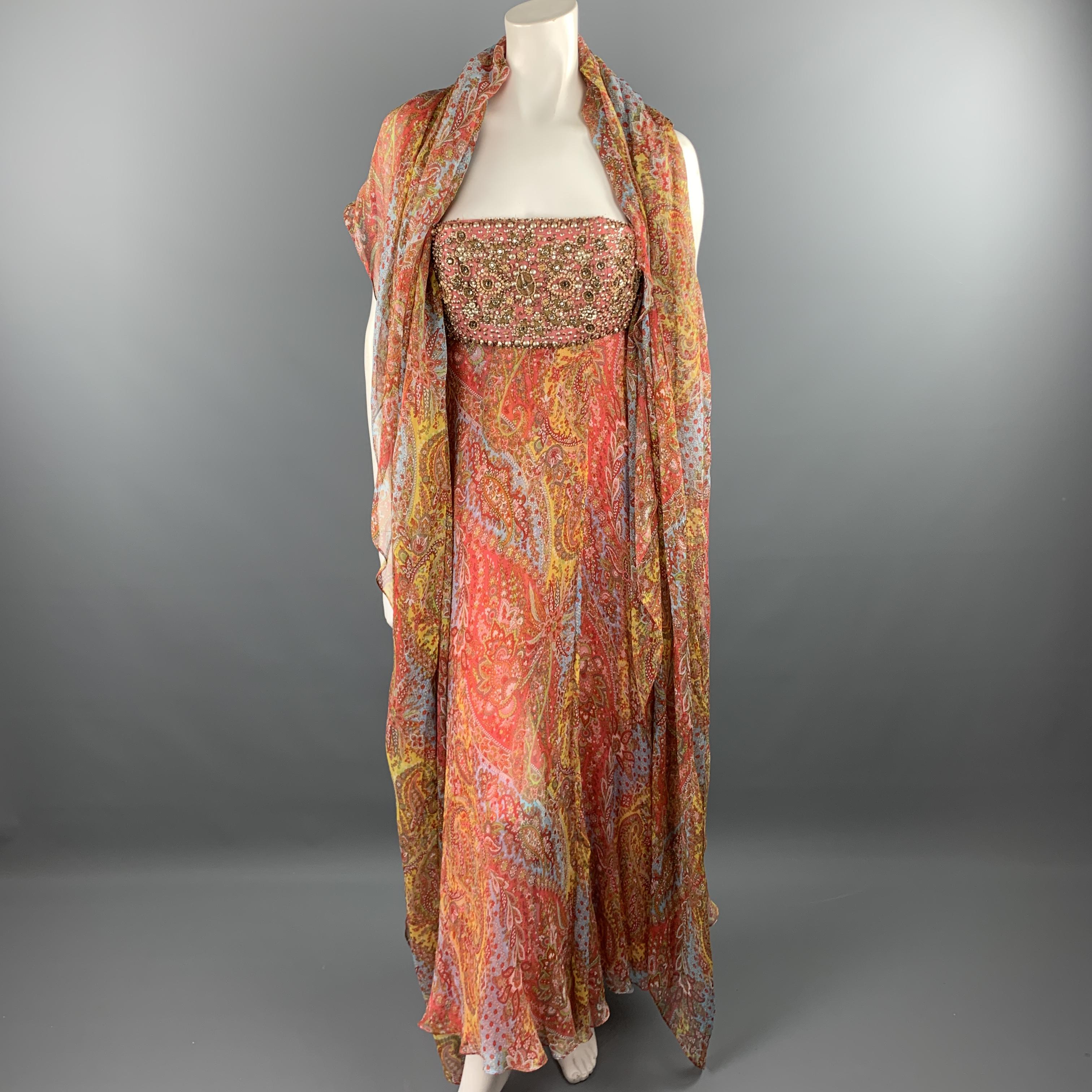 NAEEM KHAN evening gown comes in pink silk with a multi color paisley crepe chiffon overlay, beaded embellished pink silk bustier top, and matching shawl. Made in USA.

Very Good Pre-Owned Condition.
Marked: US 6

Measurements:

Bust: 34 in.
Waist: