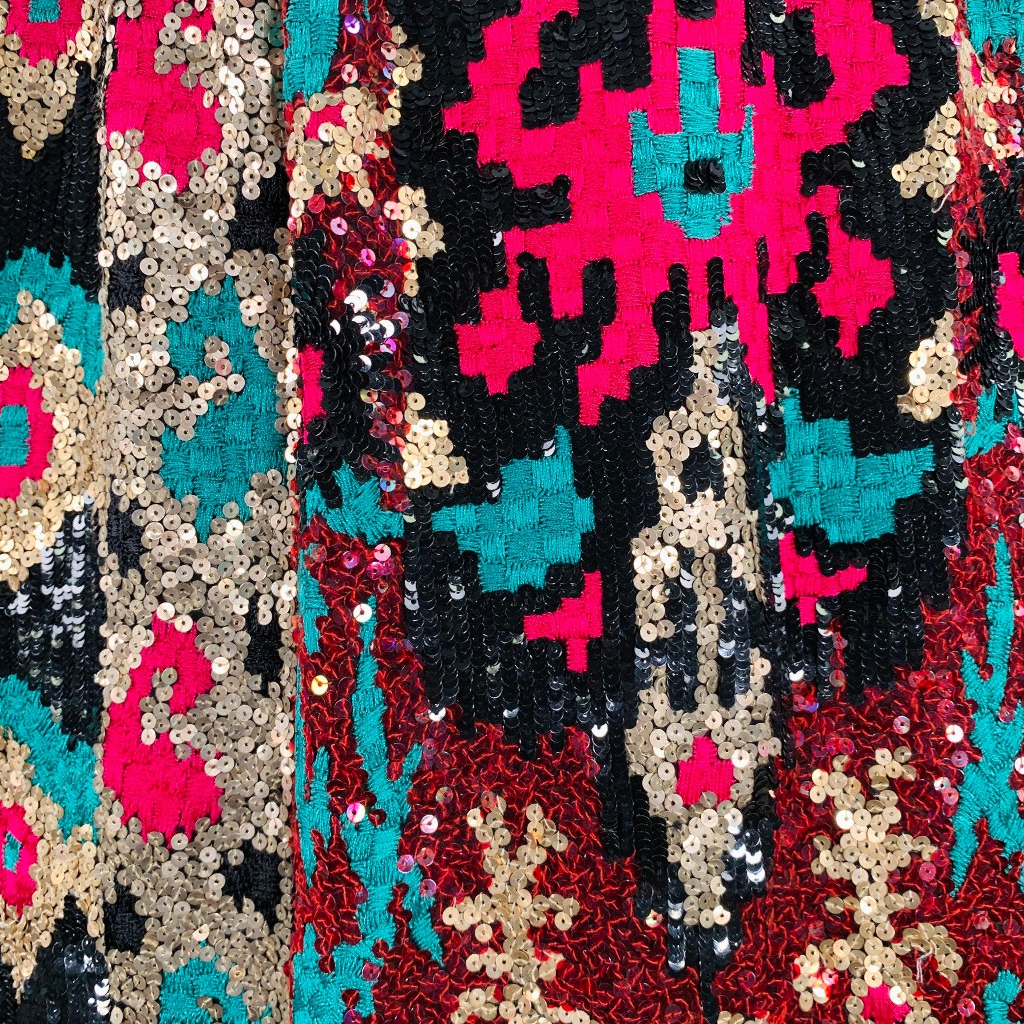 NAEEM KHAN skirt
in a black fabric featuring a geometric pattern with pink & green embroidery, gold tone sequins, and side zipper closure.Excellent Pre-Owned Condition. 

Marked:   size not marked 

Measurements: 
  Waist: 26 inches Hip: 36 inches
