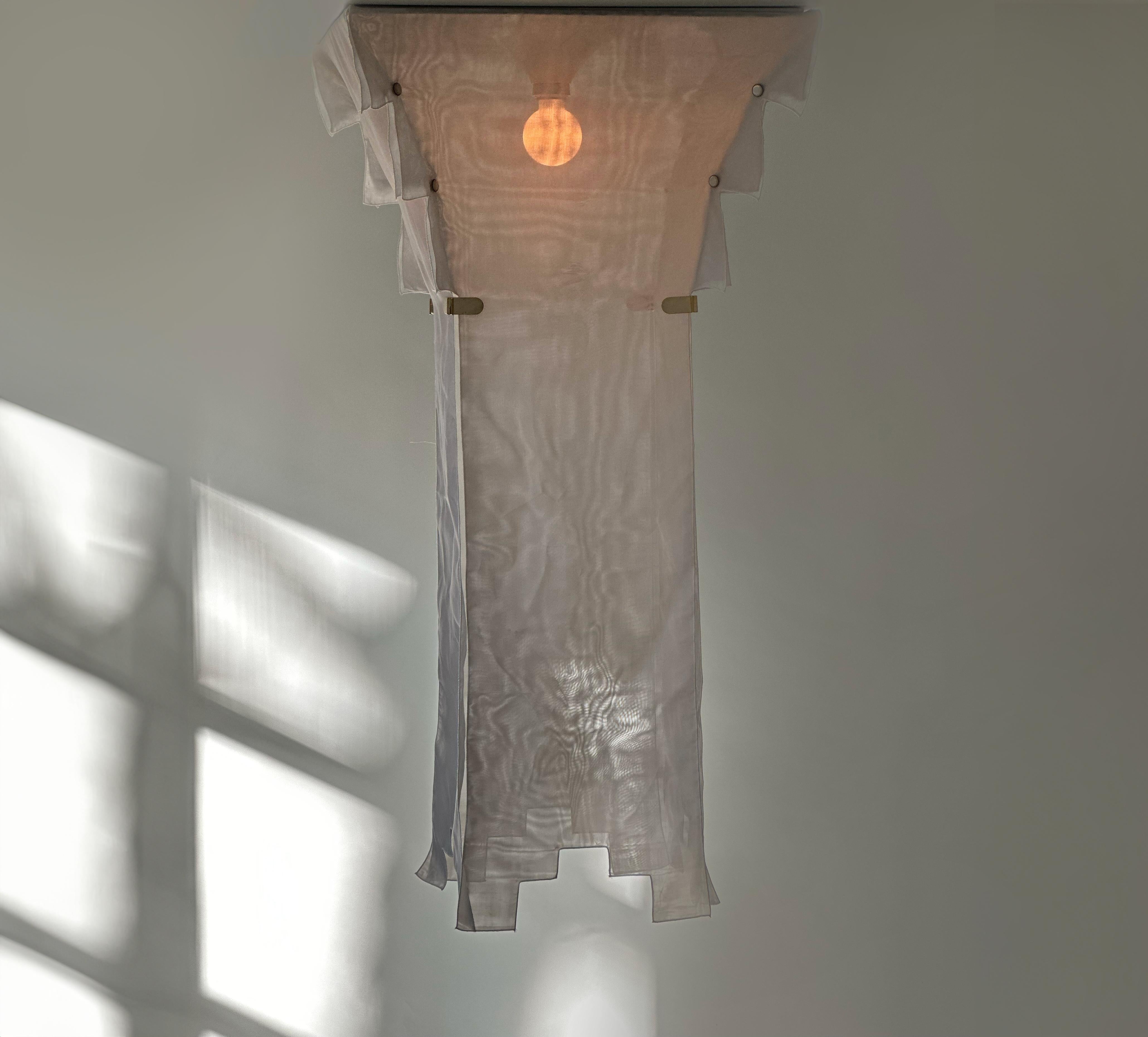 Naeko Chandelier by Kazuhide Takahama for Sirrah, c. 1985. Italy

Naeko Chandelier designed by Kazuide Takahama and manufacutred in Italy by SIrrah. This light features removeable white silk like fabric panels connected by brass clips and pearl