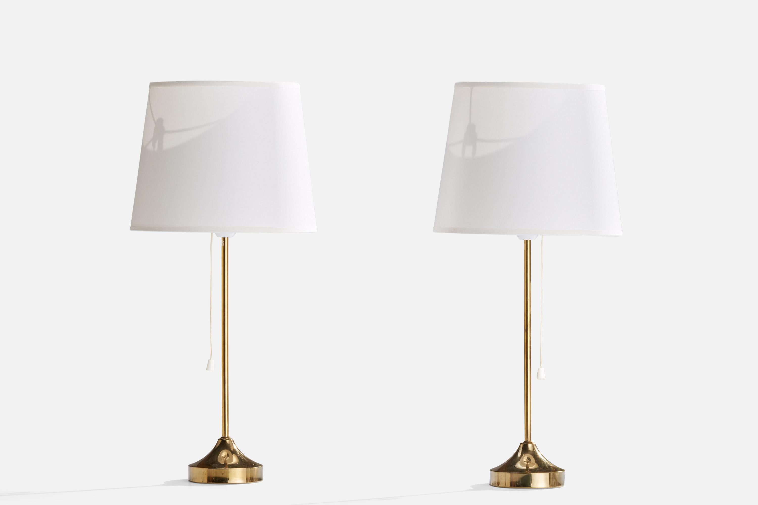 A pair of brass and white fabric table lamps designed and produced by NAFA, Sweden, 1950s.

Dimensions of Lamp (inches): 15.75” H x 4” Diameter
Dimensions of Shade (inches): 8”  Top Diameter x 10”  Bottom Diameter x 8” H
Dimensions of Lamp with
