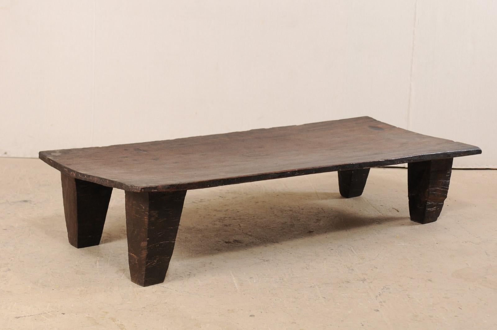 A Primitive wood Naga daybed, which we think makes a fabulous coffee table, from the early 20th century. This antique wooden bed from the Naga tribes of Nagaland, North East India has been carved out of a single log and would make for a great coffee