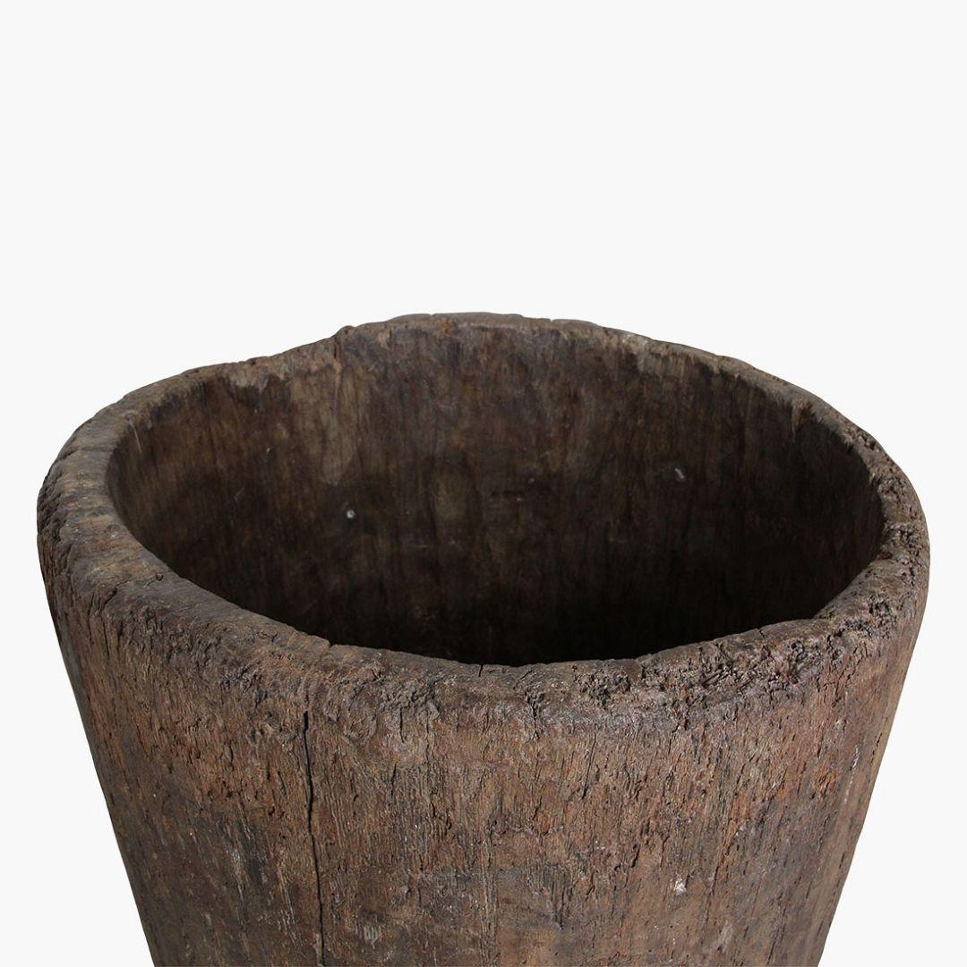 Sculptural and functional, this rare wooden vessel hails from the remote highlands of Nagaland, a culturally rich region in northeastern India. Carved from a single trunk of what is likely Saal wood, the piece exemplifies the Naga people's
