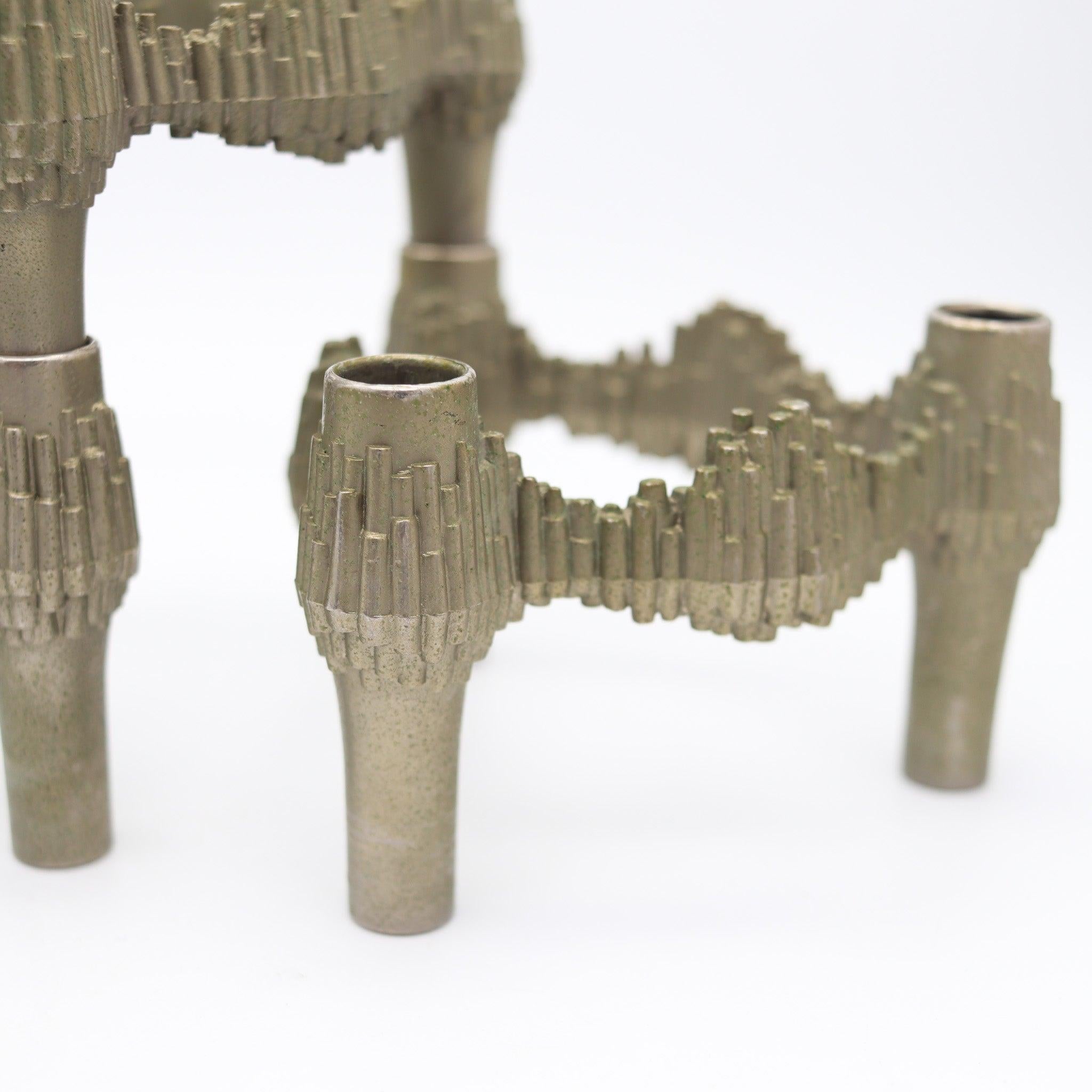 A suite of three candle holders designed by Caesar Stoffi.

This is a nice vintage set of three stackable candle holders created in Germany during the modernist period, back in the 1970. They were designed by Caesar Stoffi for the Nagel Quist
