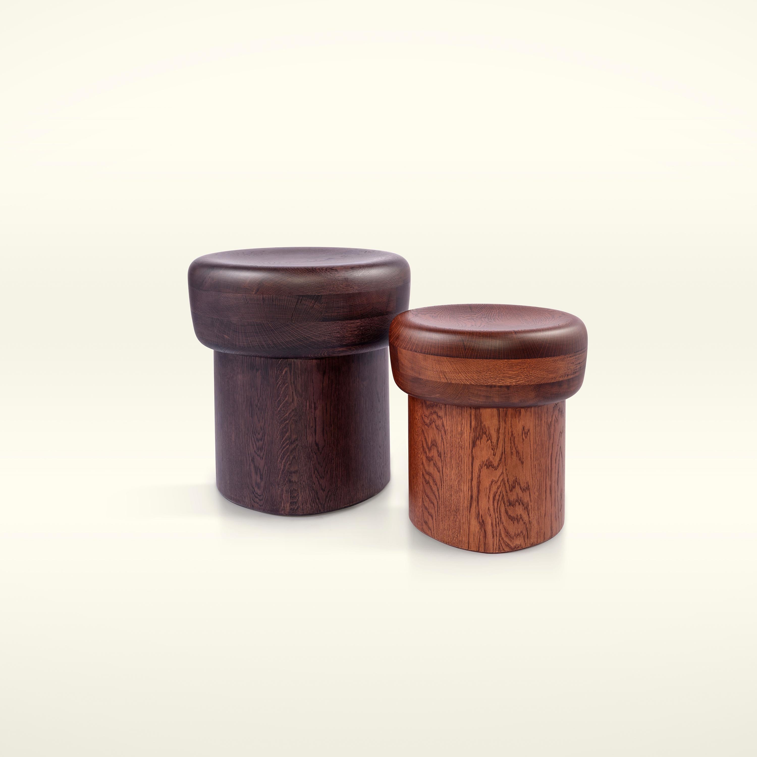 Nairobi Stool - Size L is crafted from solid wood. Simple yet bold and sculptural, it is a member of a series of stools that derive their names from African cities, inspired by the artistry of African sculptures reflected in their forms. 