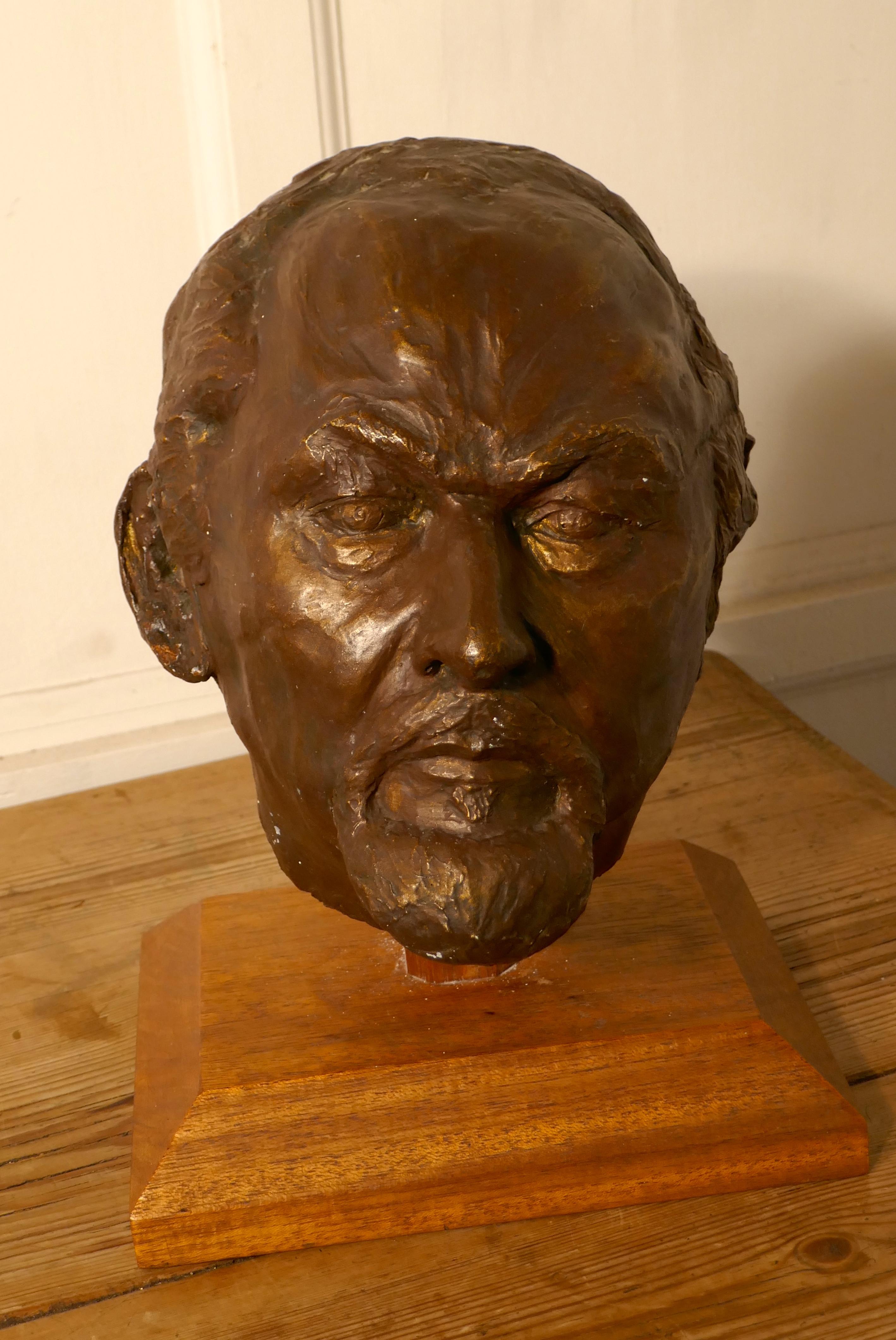 Naive life-size simulated bronze plaster head of bearded Man, not signed

This is good handmade piece dating from the middle of the 20th century, it shows a three dimensional head of a man with a beard, the sculpture is set on a new wooden