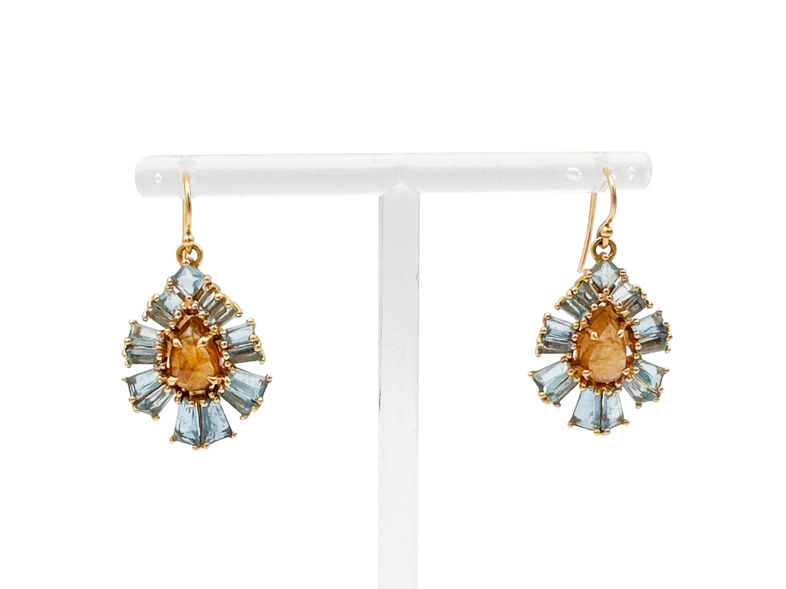 Stunning Nak Armstrong designer drop earrings in a fluttery, elegant design. The earrings featuring 5.6 carats of tapered baguette-cut aquamarine and 4.26 carats of pear-shaped brown zircon; a total of 34 stones in proprietary cuts, individually set