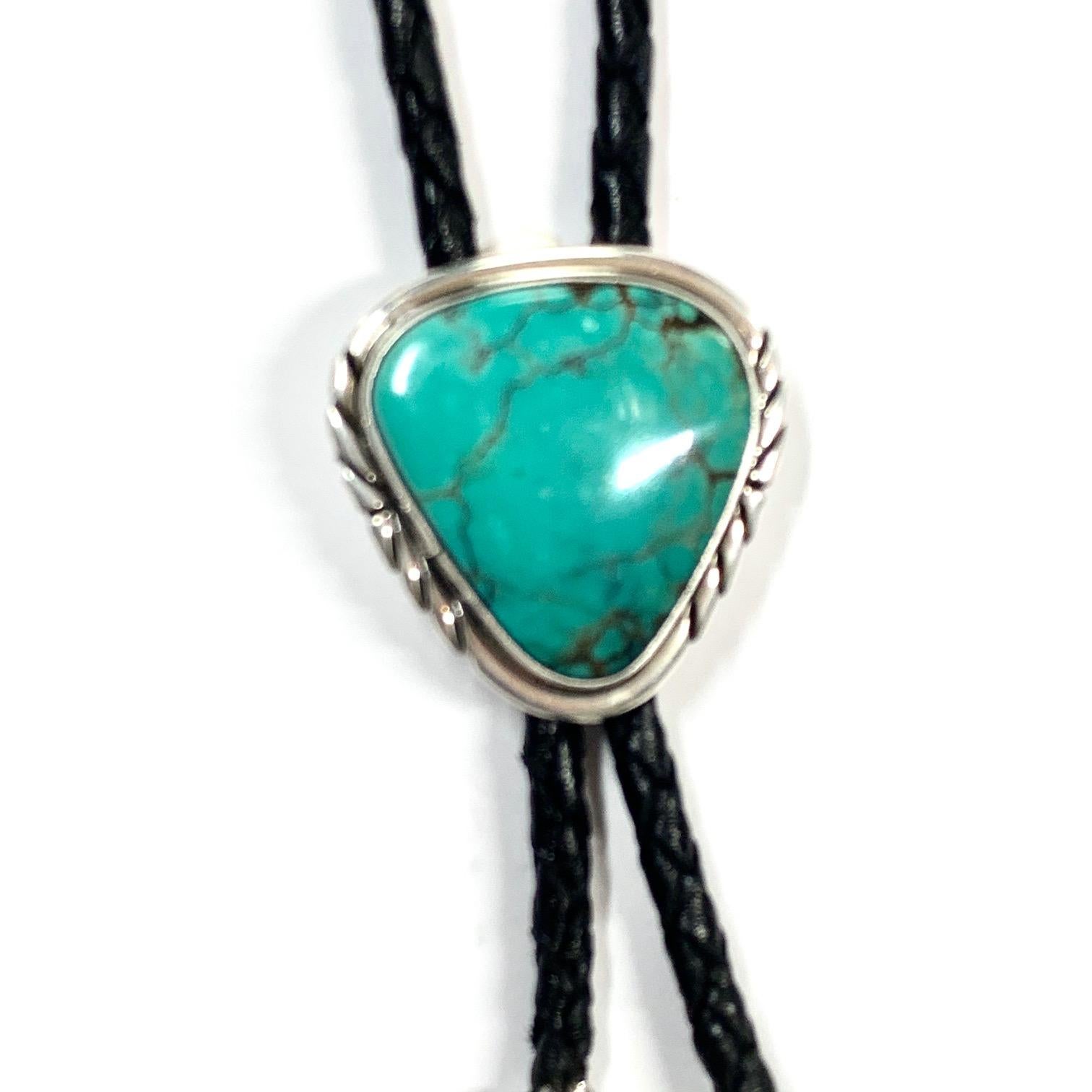 Nakai Navajo Sterling Turquoise Bolo Estate CCBOLO11

Nakai does it again, he brings to life this magnificent bolo tie crafted on 25 g of genuine silver and a gorgeous Mexican triangle cushion (30x30x36 mm) bezeled in a very symmetrical frame this