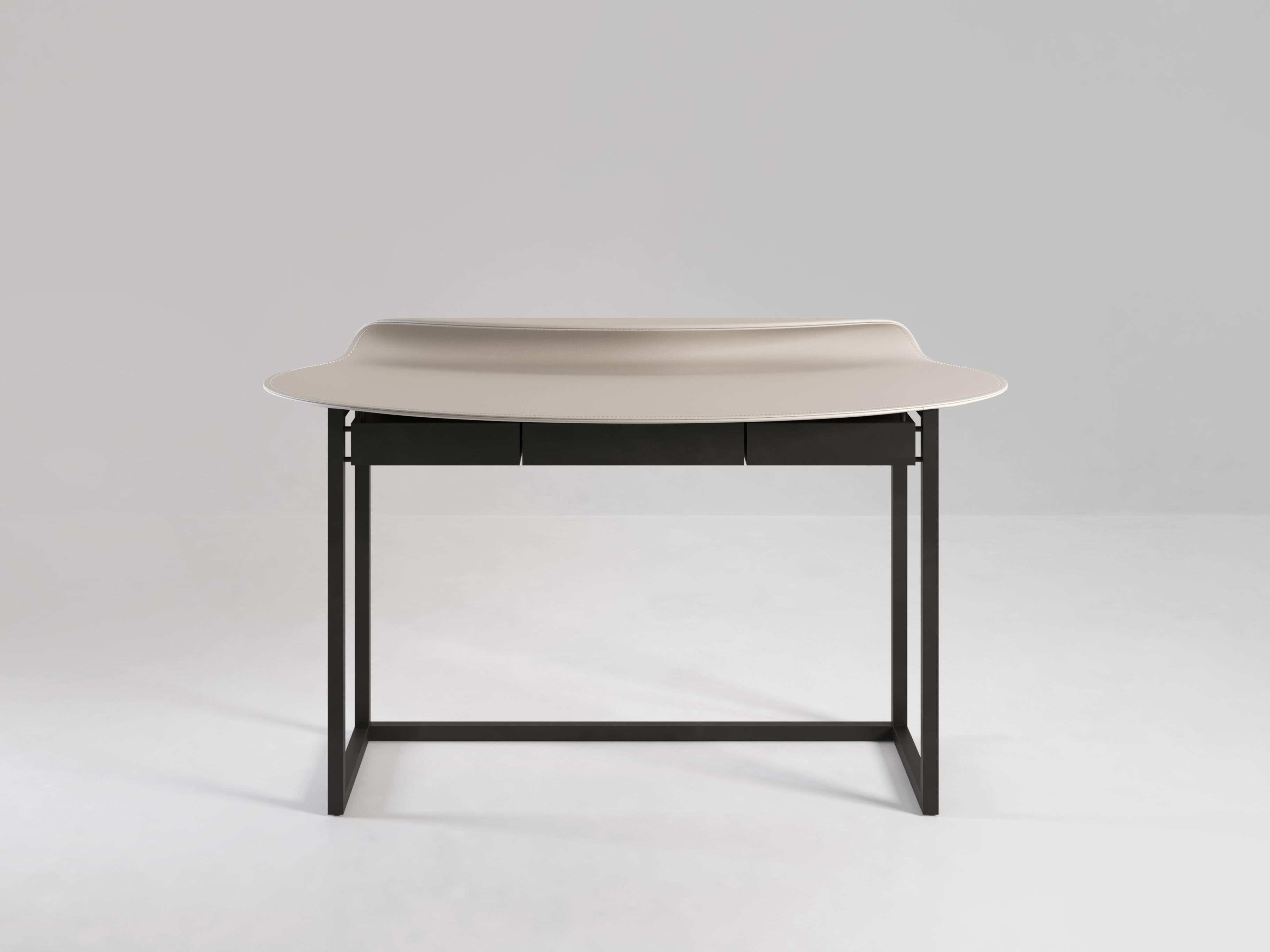 The Nakamura desk is an exploration of the possibilities and precision of expert leather-working. Two pieces of leather curve around the table top and meet at only one continuing line. Available in various leather options and with or without