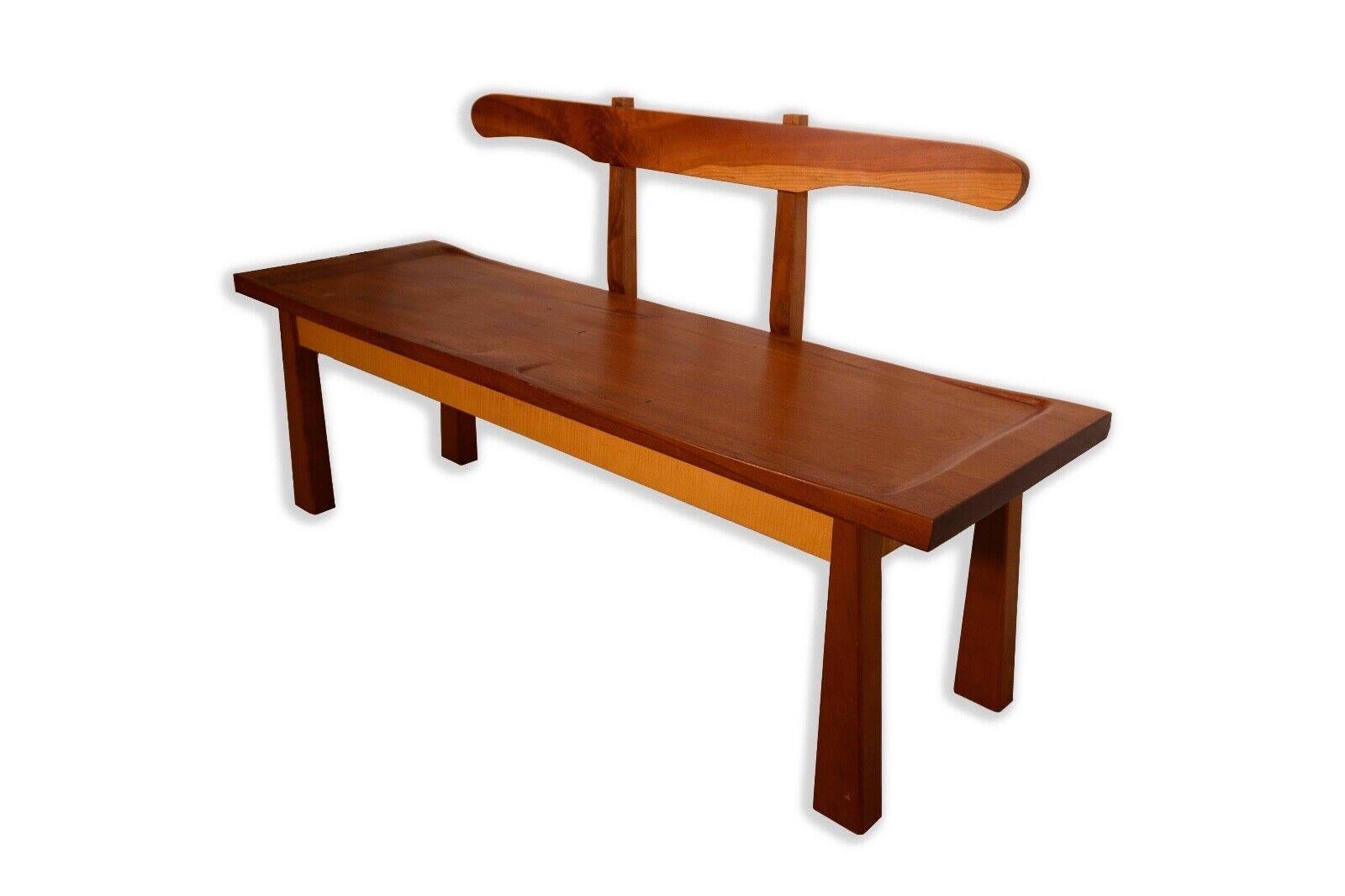 This Nakashima-styled wooden bench with divided seats is a testament to the enduring appeal of Mid Century Modern design. Crafted in the spirit of George Nakashima's iconic furniture, the bench features a beautifully grained wooden construction,