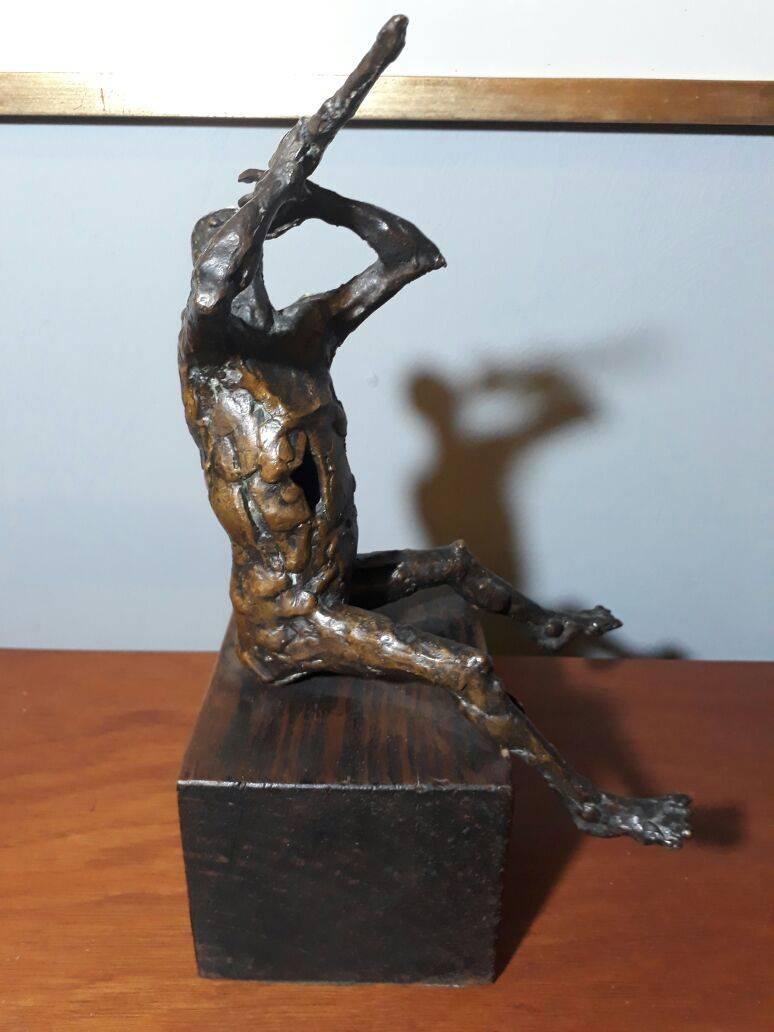 Naked man with flute made in bronze by unidentified author.
Signed by LK.