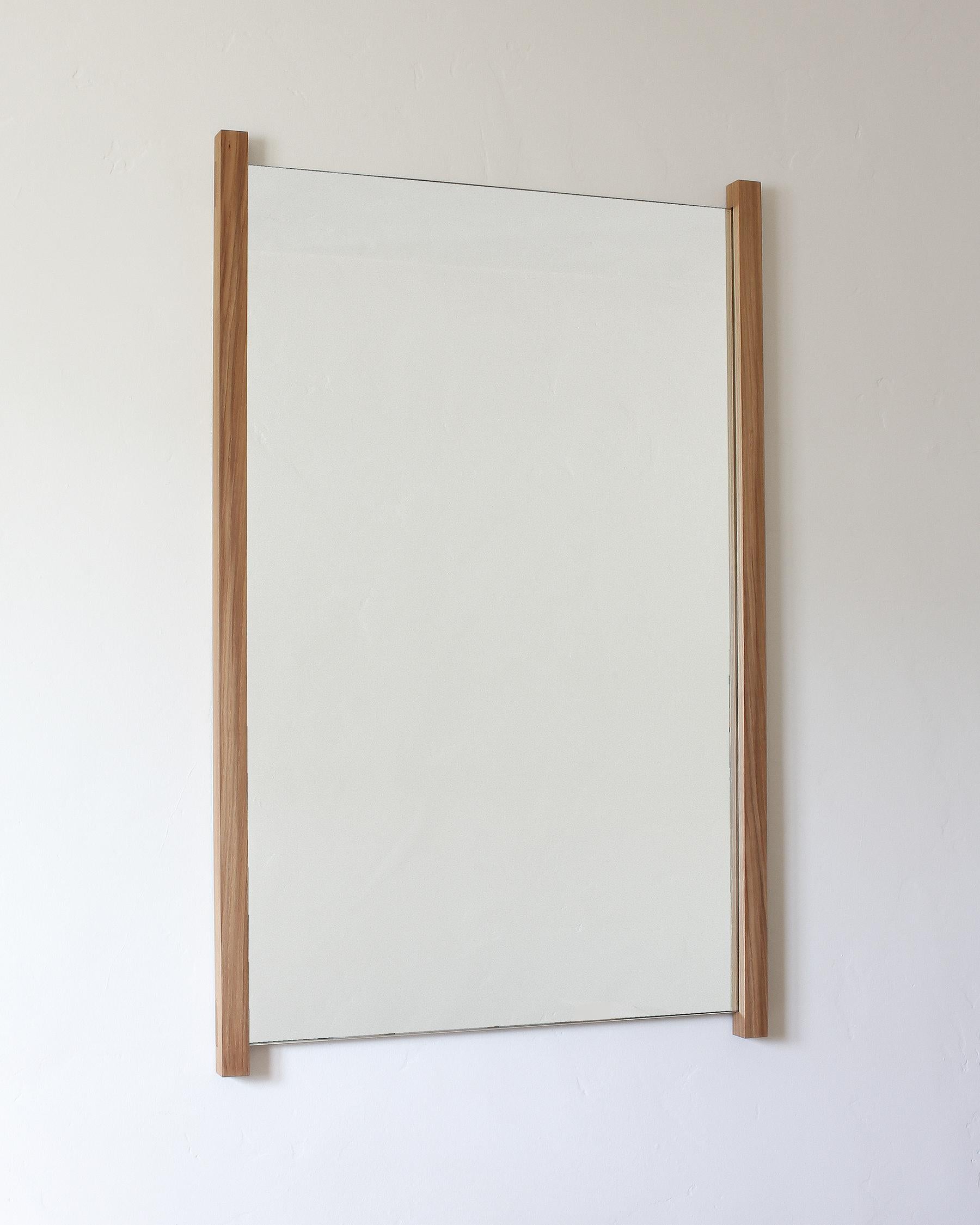 This is a listing for a made to order wall hanging mirror frame only. The mirror glass will need to be ordered separately in your locale. This saves on shipping and overall cost of frame. Lead time 3-4 weeks. Solid white oak frame visible at sides