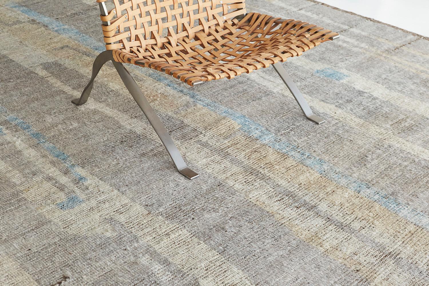 Nakhla is a natural earth-toned rug and a modern interpretation of the Moroccan world. These rugs' irregular patches of cream, blue, and gray resemble the fibers of nature and their ability to be used for crafts such as cords and basketry. Designed