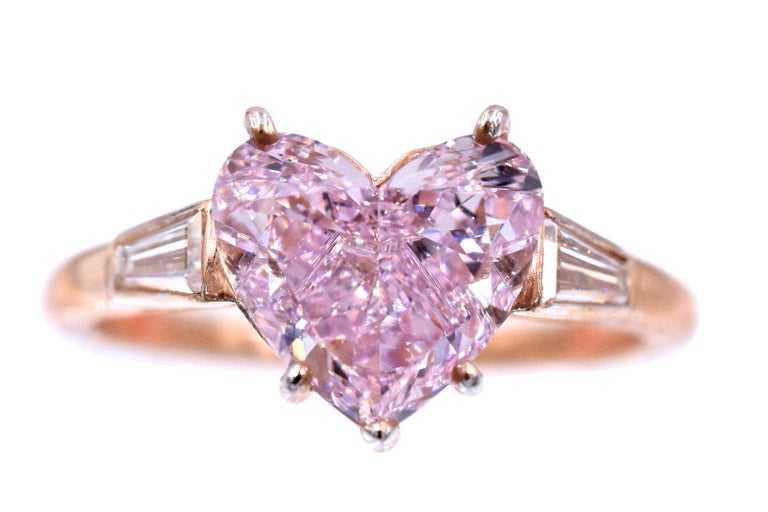 NALLY 2.02ct Fancy Purple- Pink Diamond Ring. The diamond is set in a Cartier Mounting with 2 Tapered Baguette Cut Diamonds, with an approximately total carat weight of 0.25CT, stamped CARTIER and stock numbered. The center stone is a 2.02ct Heart
