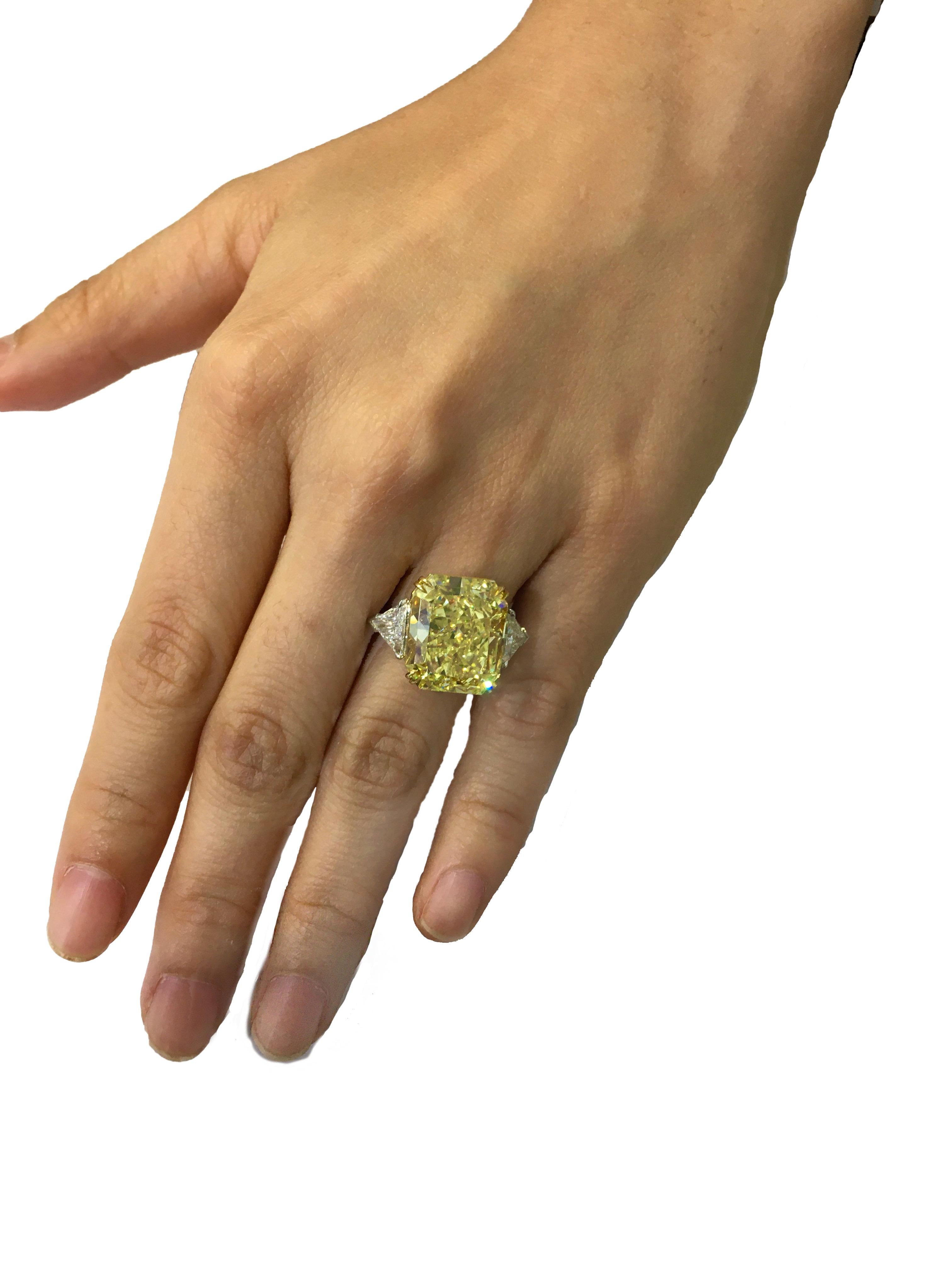 Only the best!
Fancy Intense Yellow Radiant Shape Diamond Ring
Center diamond is:
Size     14.71 carat 
Color   FIY (Fancy Intense Yellow) 
Clarity VS1 
GIA # xxxxxxxx
Set in platinum with two trillion shape diamonds with 2.40 carat, D color VS1