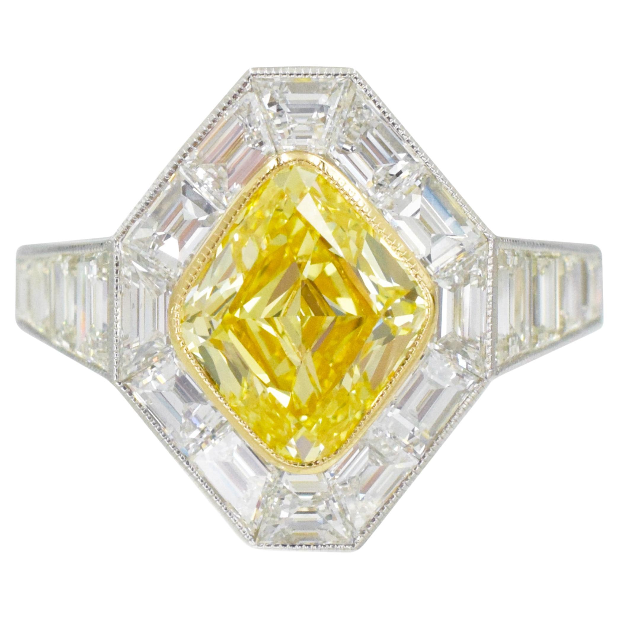 Nally Jewels Intense Fancy Yellow GIA certified Diamond Ring 
Diamond, Gold and Platinum Mounting.
This ring has 18 step cut diamonds weighing a total of 1.87 tcw all bezel set in platinum with a center diamond of 2.05 carat rhomboid brilliant